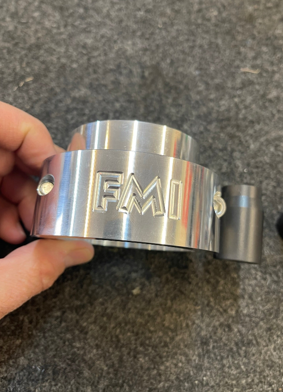 Close-up of the 2025 Ram RHO 2 inch Front Leveling Kit component, showcasing its polished metal finish and detailed branding.
