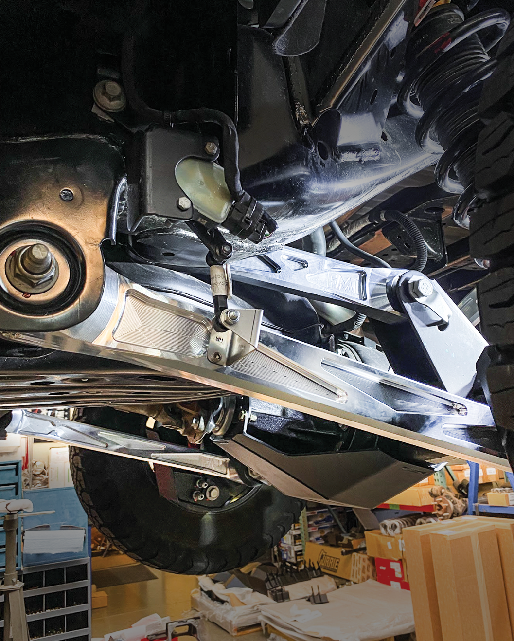 2024 Ranger Raptor rear suspension kit featuring billet aluminum arms and ultra-flex joints installed under a vehicle.