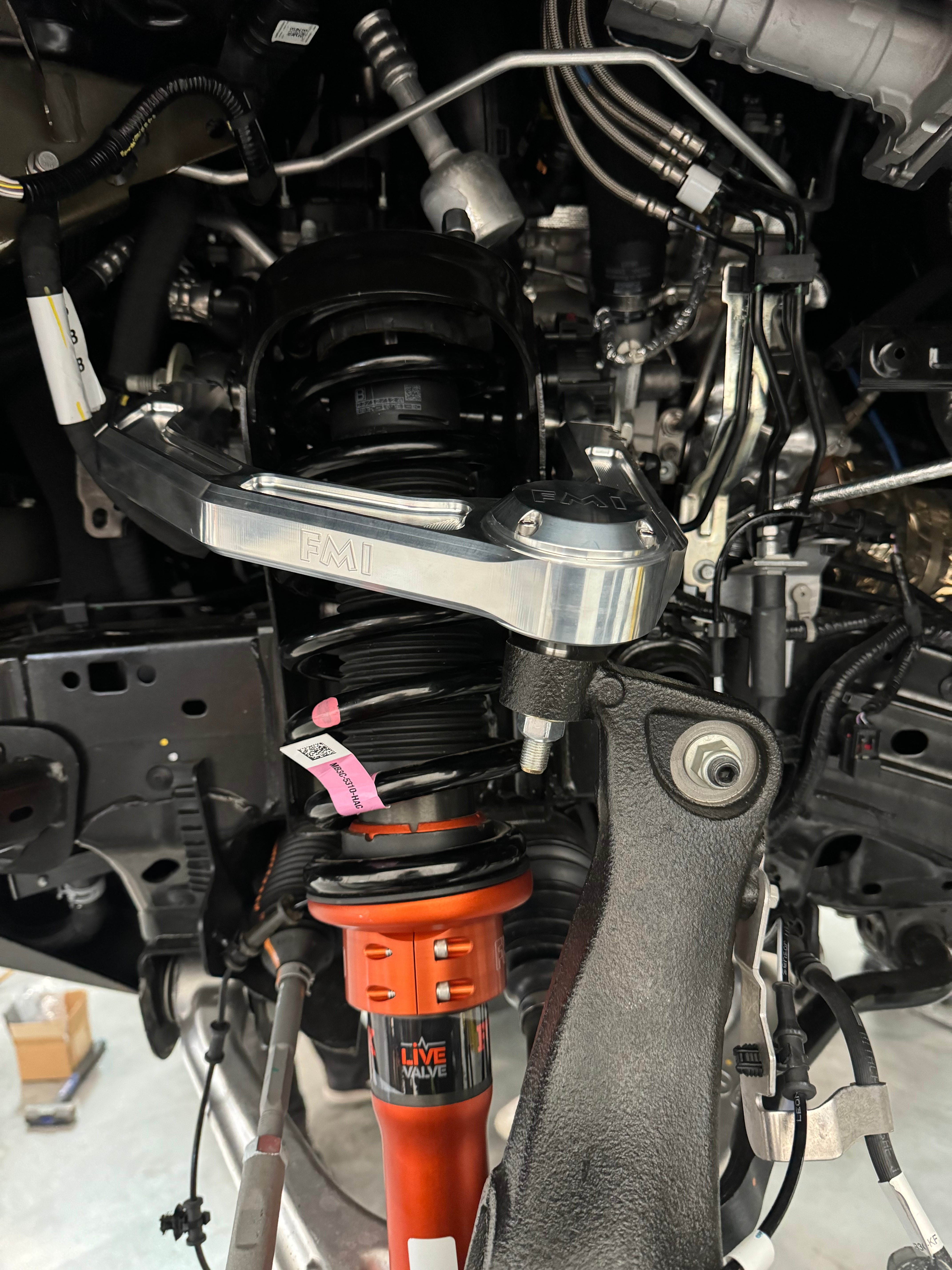 2024 Ranger Raptor billet upper control arm kit installed, showcasing stock length and suspension components.