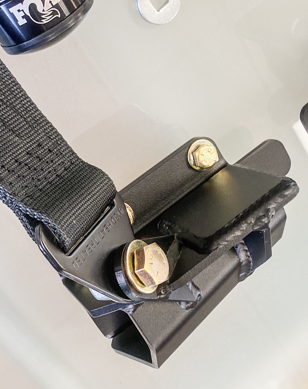 Front limit strap kit and bump stop for 2024 Ranger Raptor, designed for stock lower arm installation. Durable materials.