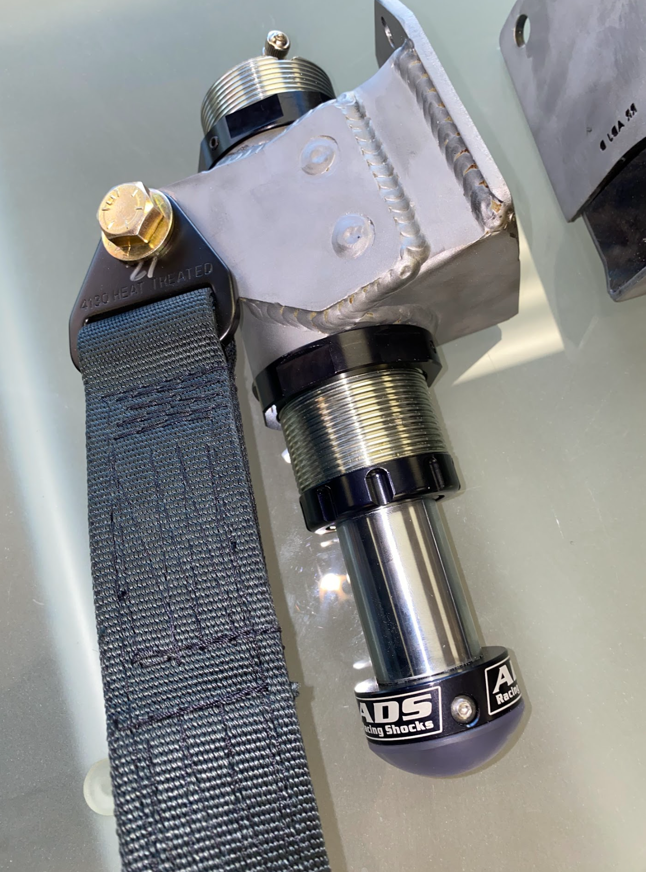 Front limit strap kit and bump stop for 2024 Ranger Raptor's stock lower arm, designed for enhanced off-road performance.