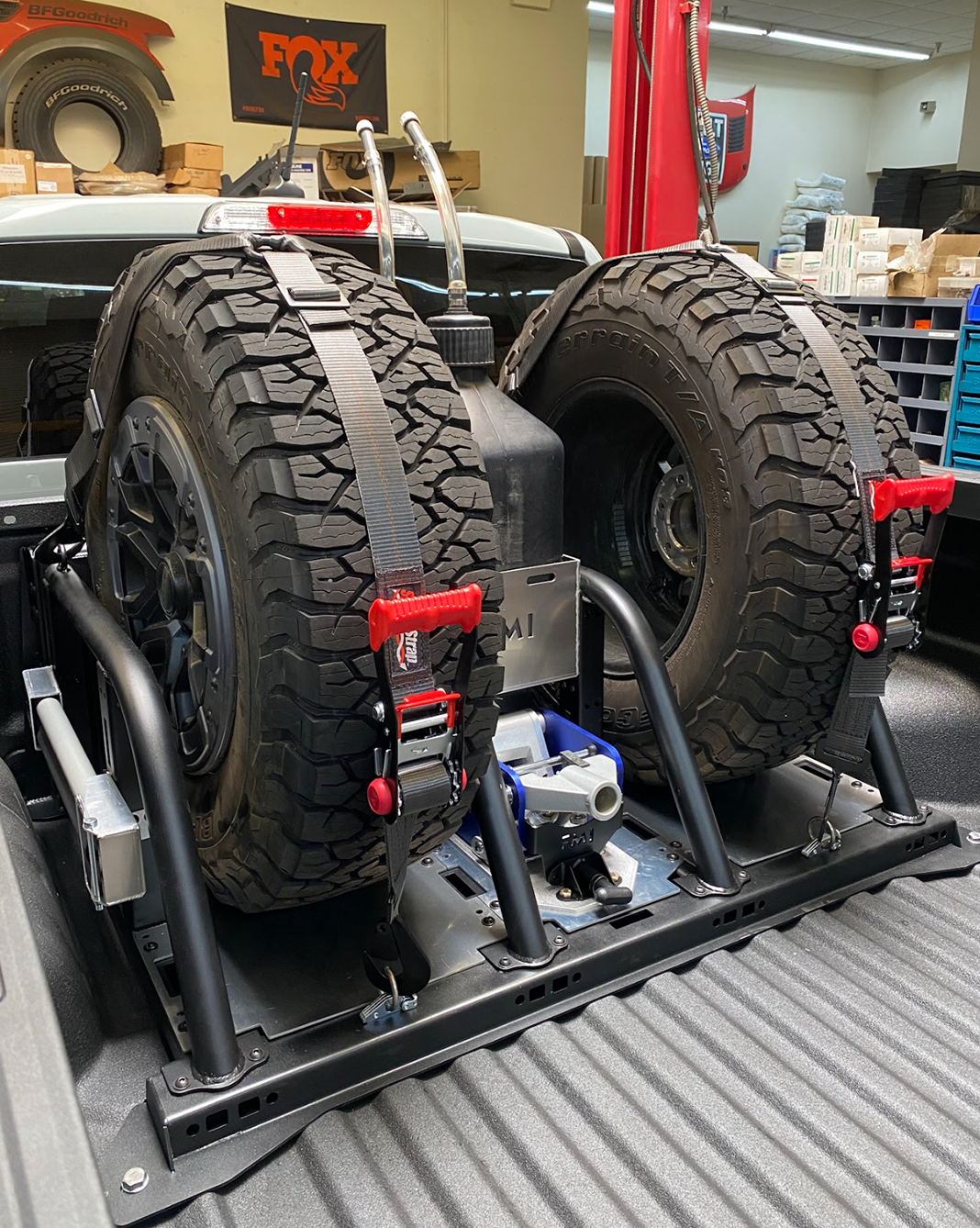 Modular bed organizer for 2024 Ranger and Ranger Raptor, securely holding spare tires and tools in the truck bed.