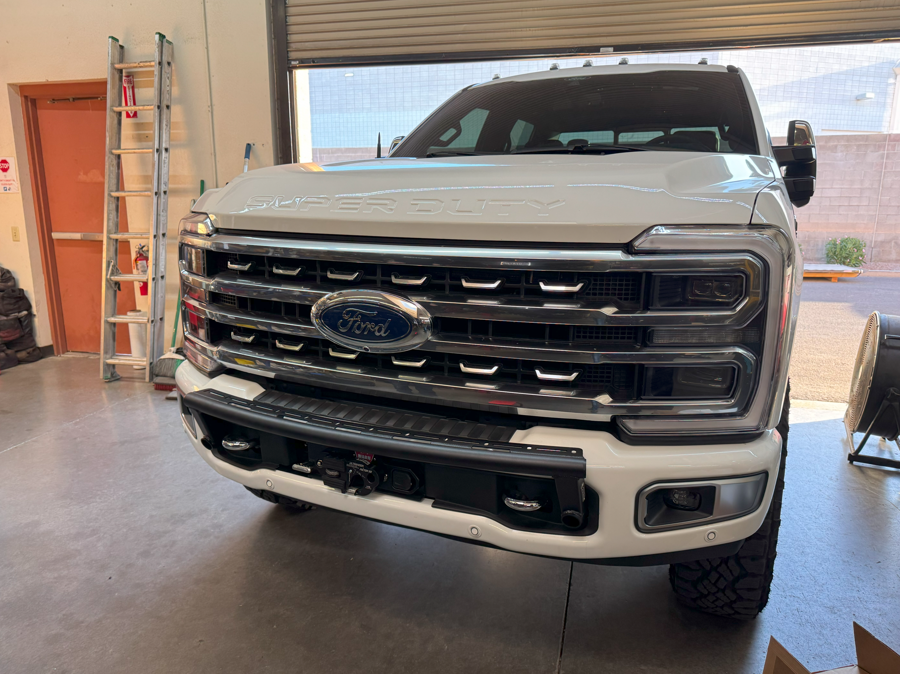 2023+ Ford F-250 Super Duty front light mount kit installed on stock bumper, showcasing a rugged and modern design.