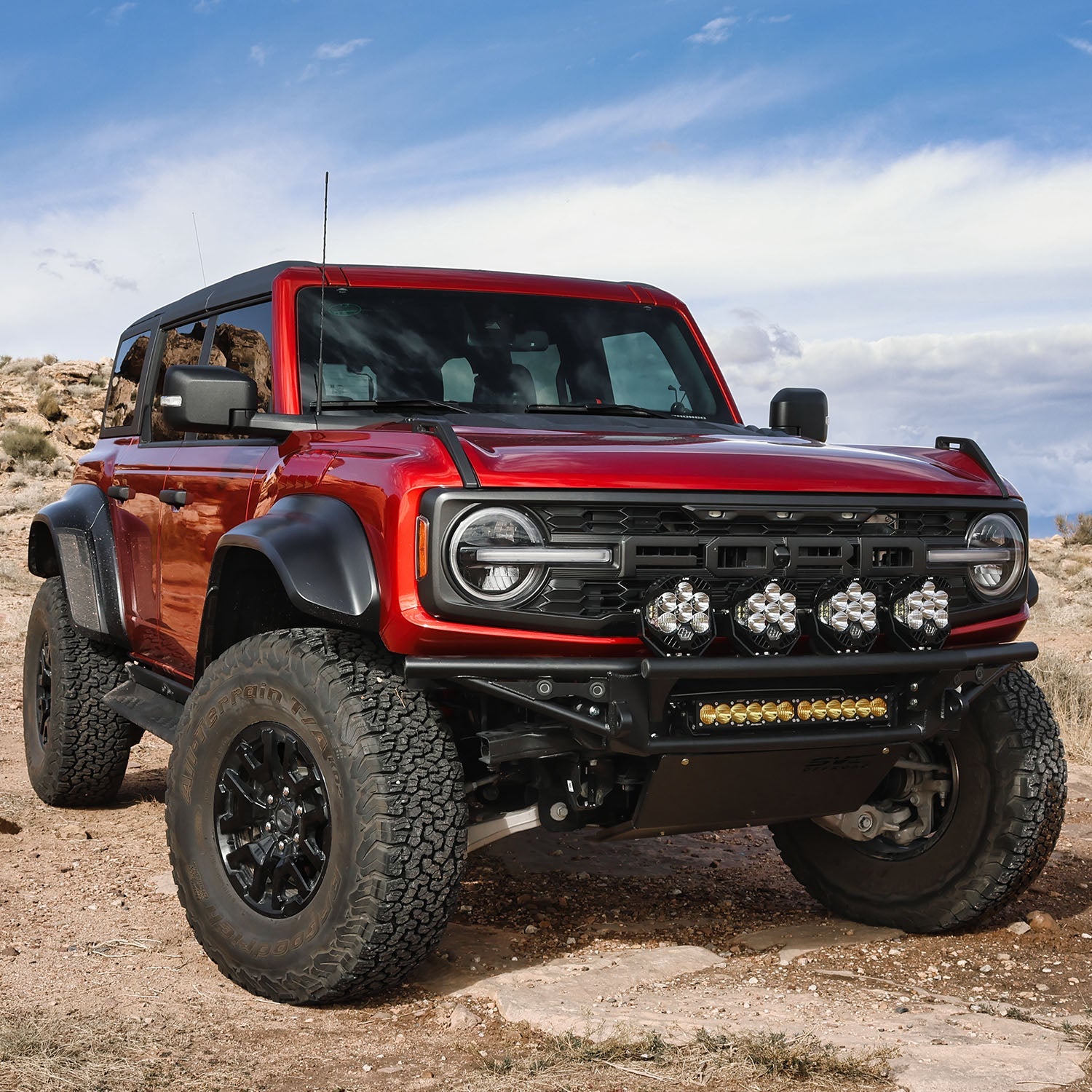 2021 Ford Bronco Baja bumper with off-road lights, showcasing rugged design and enhanced front protection in a desert setting.