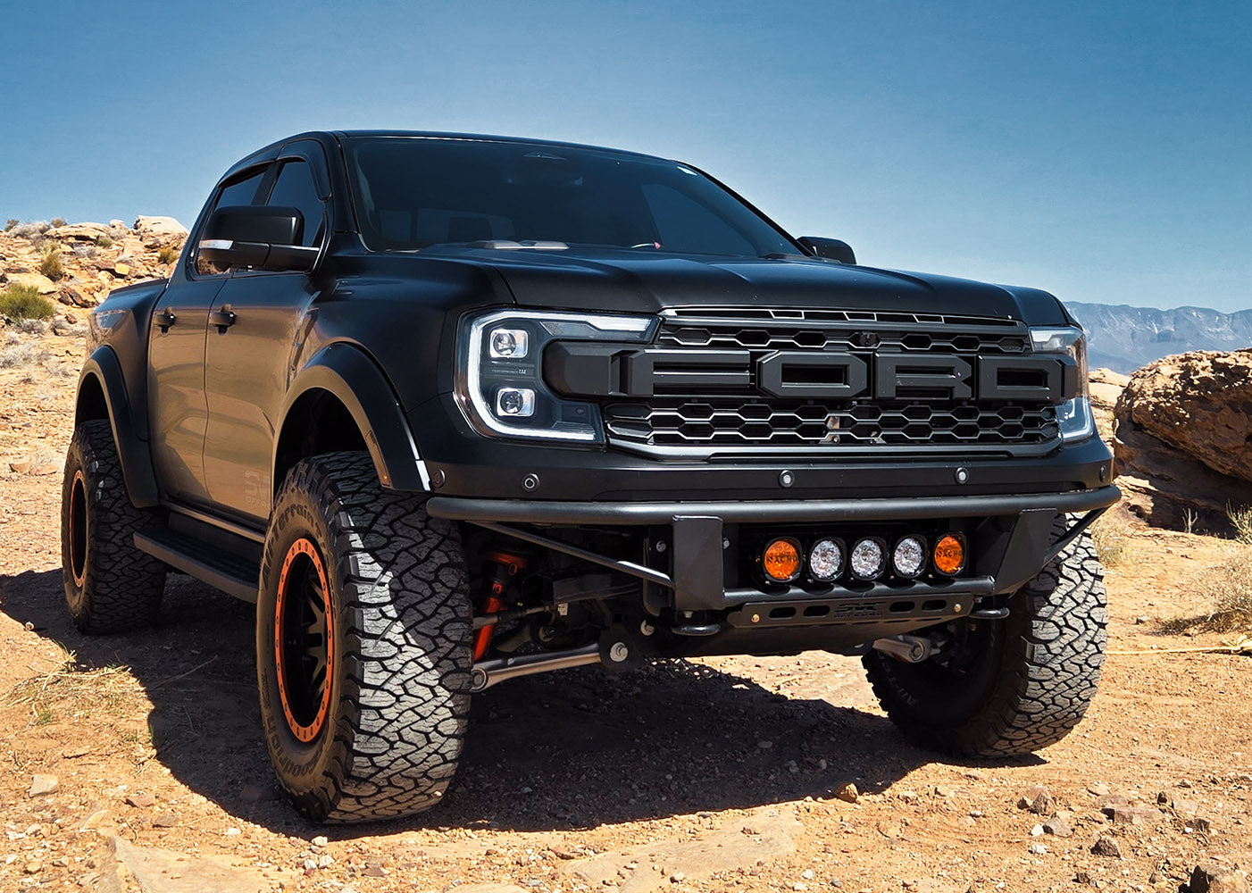2024 Ranger Raptor Baja Flush Front Bumper on a rugged truck, showcasing a bold design and off-road capabilities.