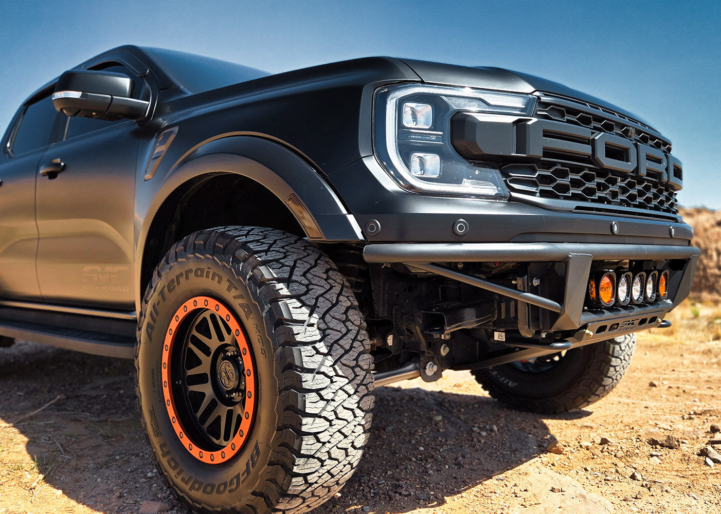 2024 Ranger Raptor Baja Flush Front Bumper on a rugged truck, showcasing aggressive design and off-road capability.