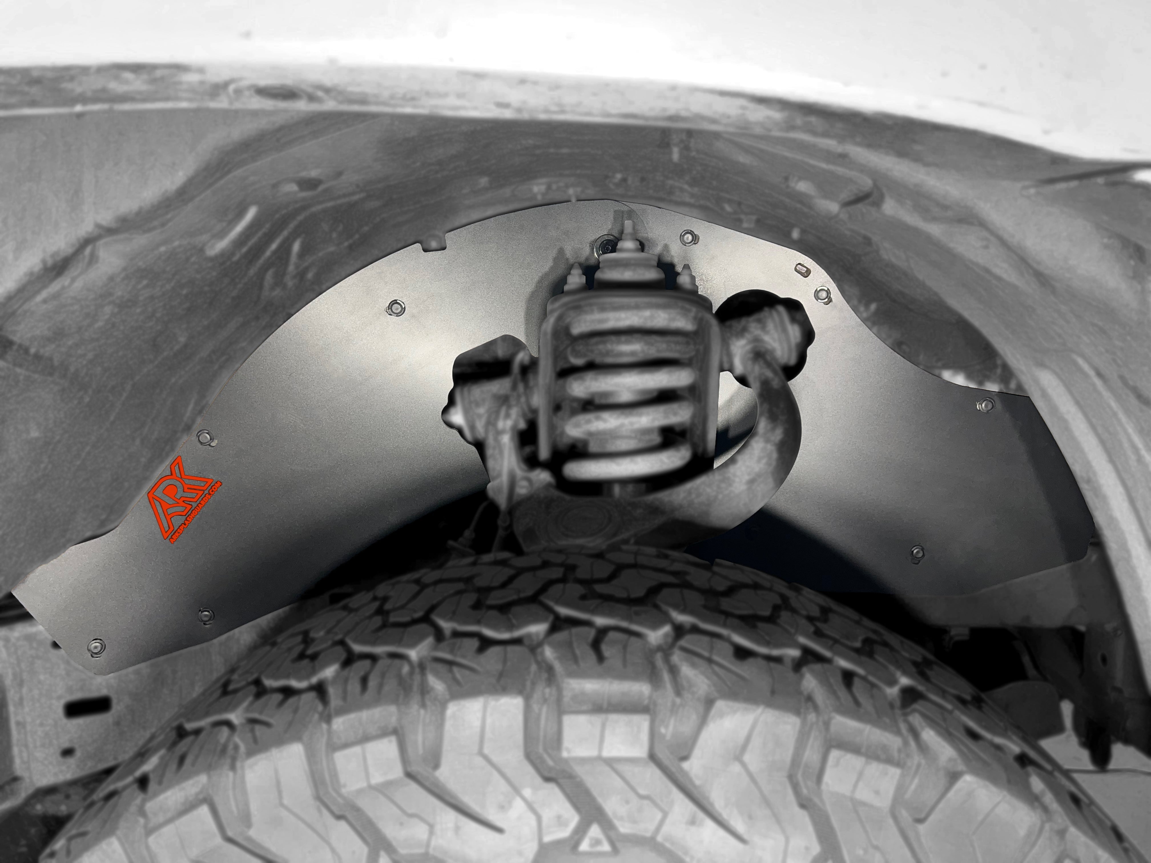 TriXpoly splash guards installed on a 2005-2015 Toyota Tacoma, protecting the wheel well and suspension components.