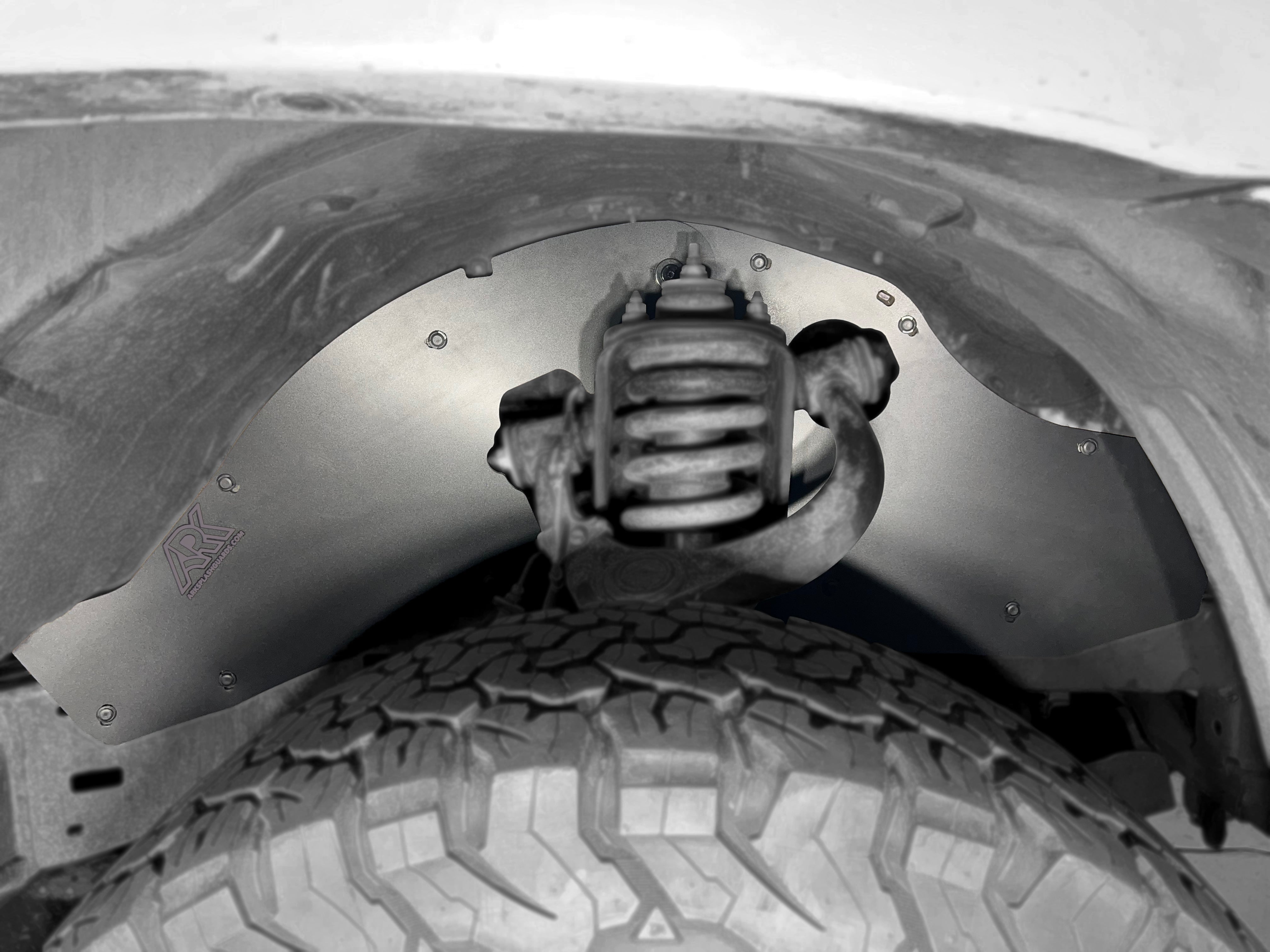 TriXpoly splash guards for 2005-2015 Toyota Tacoma, showcasing durable protection and fitment within the wheel well.