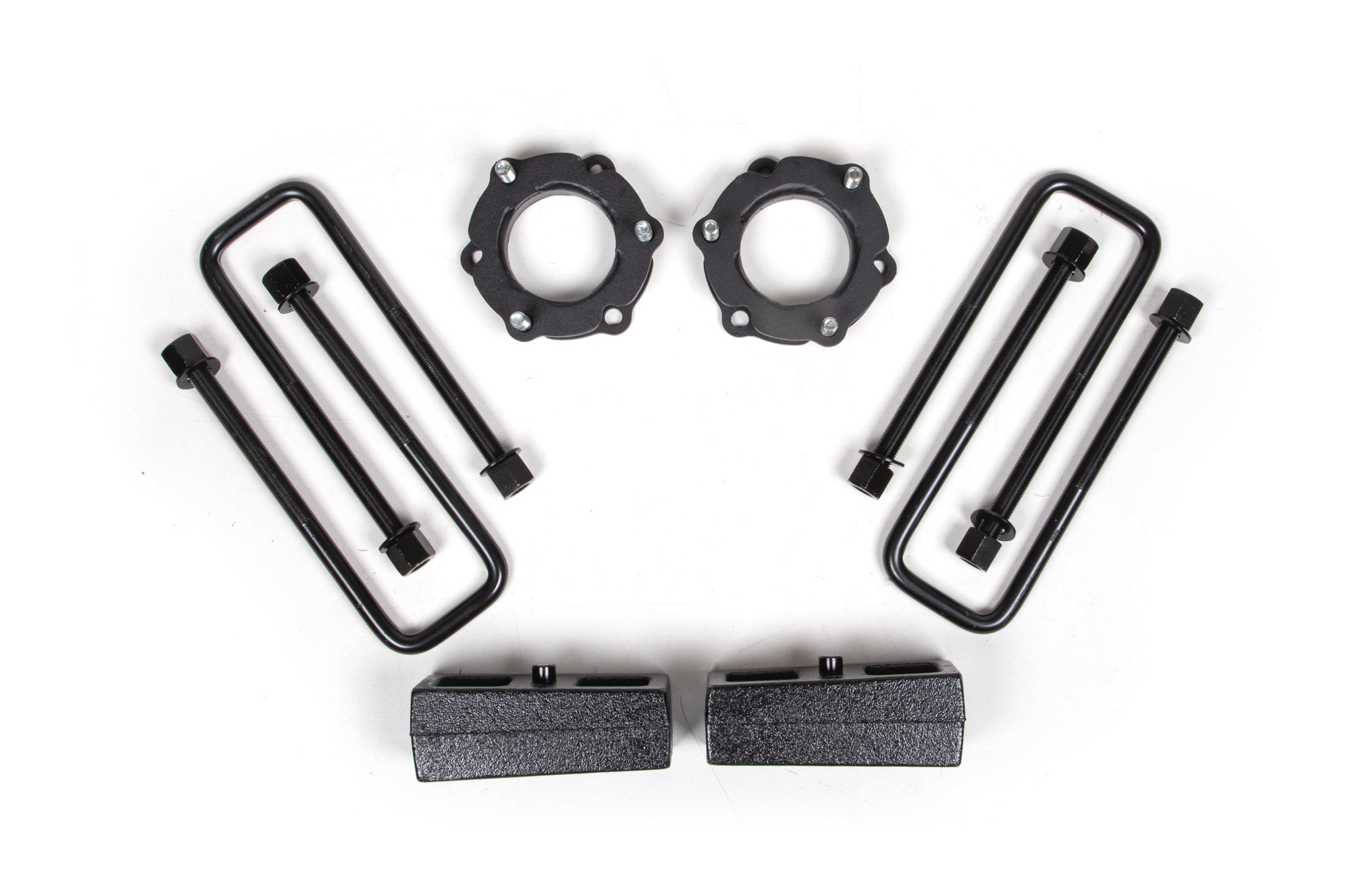 2.5 inch lift kit components for Toyota Tacoma 4WD (2005-2023) including spacers, bolts, and lift blocks.