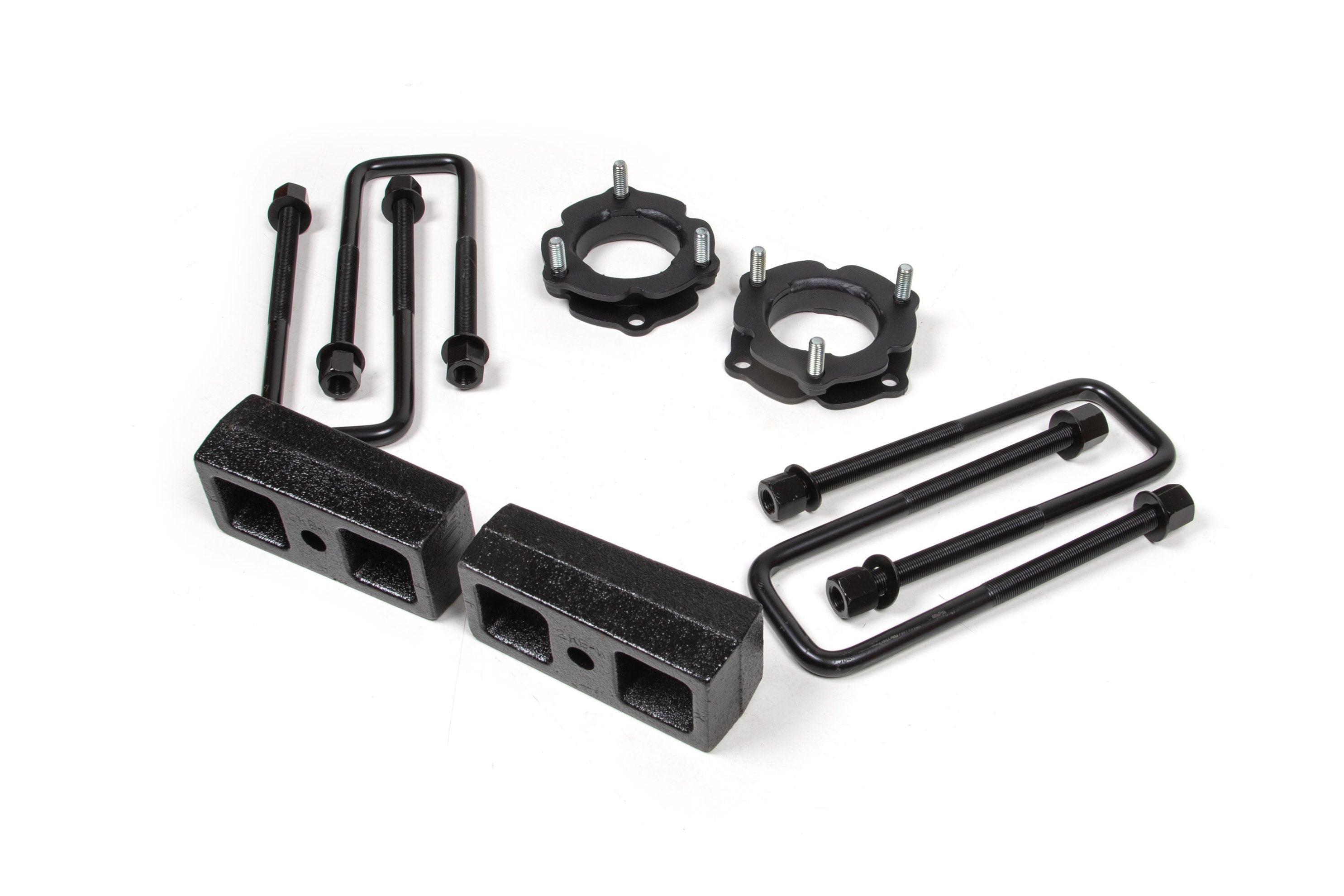 2.5 inch lift kit components for Toyota Tacoma 4WD, including spacers, blocks, and installation hardware.