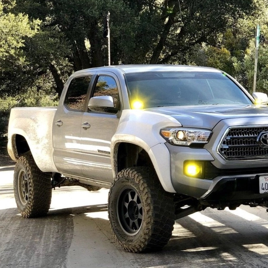 2016-2022 Toyota Tacoma with upgraded bedsides, showcasing offroad capabilities and rugged design in a natural setting.
