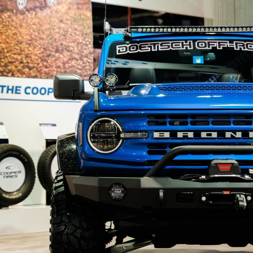 2021-2024 Ford Bronco with a Ram Air Hood showcasing offroad features and rugged design in a showroom setting.