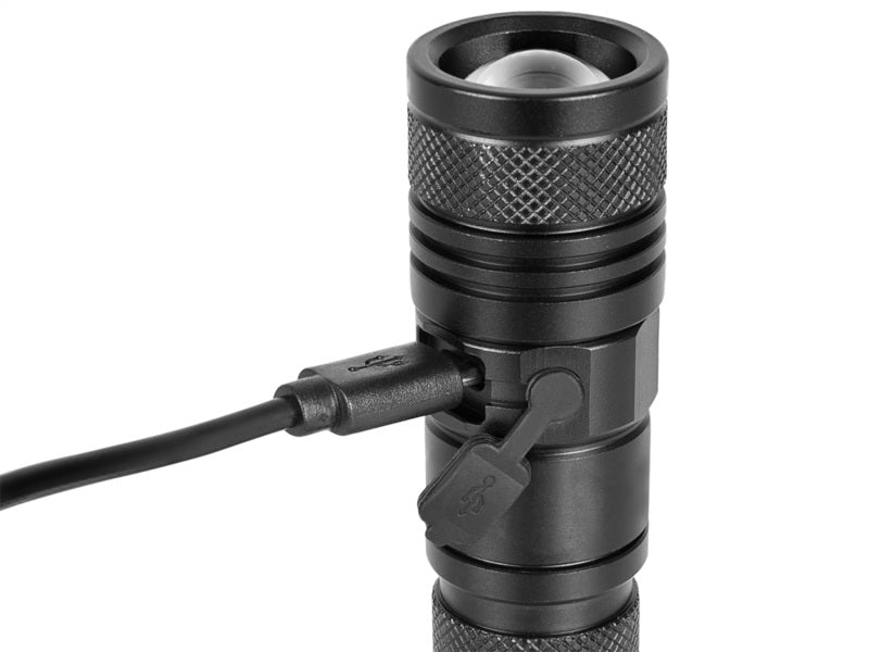 aFe Power LED flashlight with 950 lumens, featuring a sleek black design and charging port for convenience.