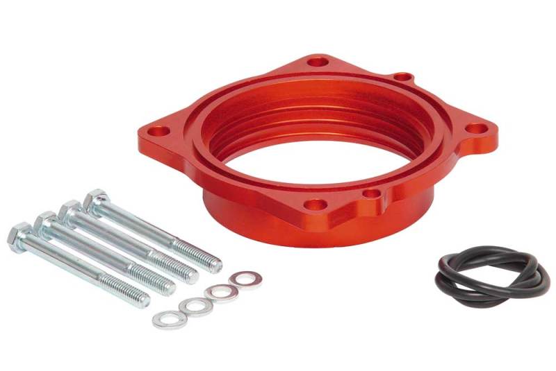 Airaid PowerAid throttle body spacer for Dodge Charger, Magnum, Challenger, and Jeep Grand Cherokee with installation hardware.