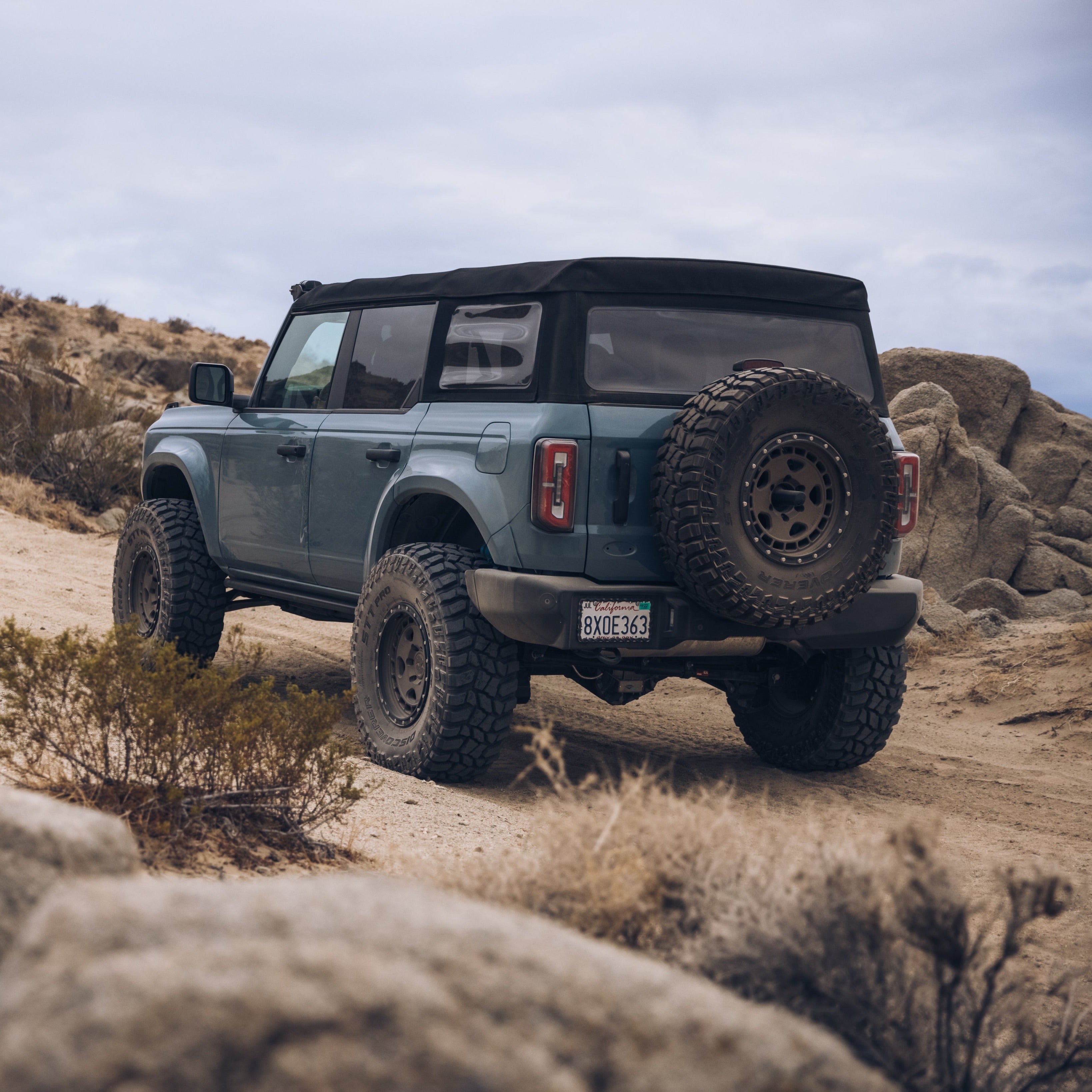 2021-2022 Ford Bronco 4-Door with rear quarter kit on rugged terrain, showcasing offroad capabilities and style.