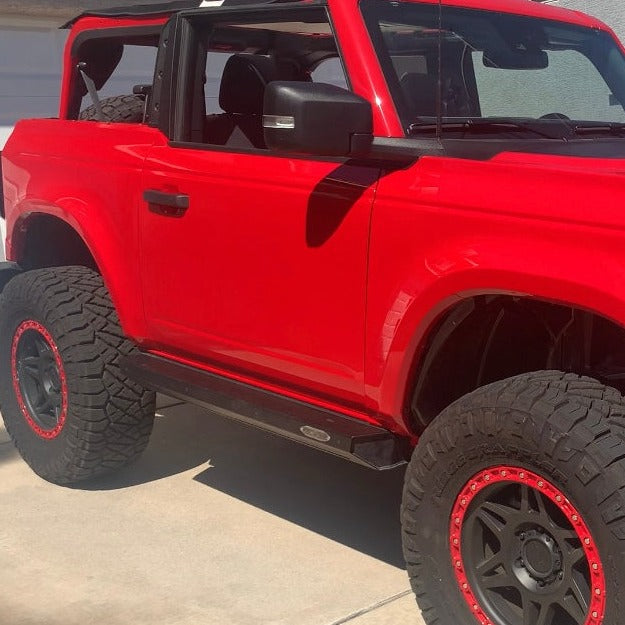 2021-2022 Ford Bronco 2-Door Rear Quarter Kit displayed on a red Bronco with offroad tires and a rugged look.