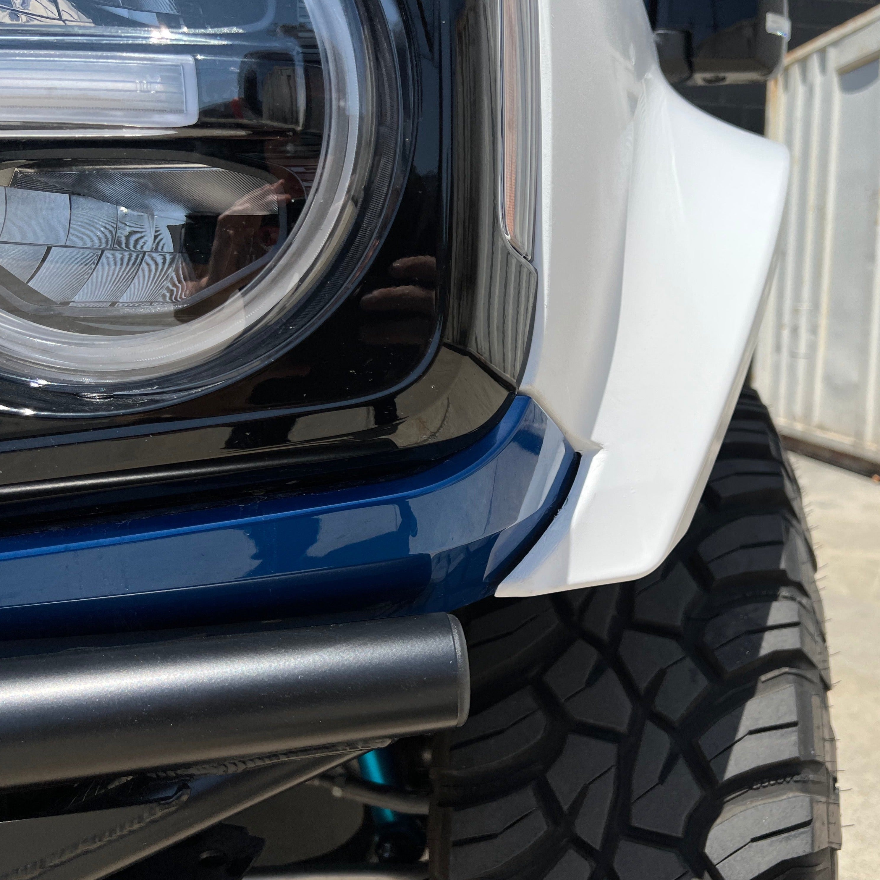 2021-2022 Ford Bronco fender showcasing a sleek design with integrated headlight and rugged tire. Ideal for offroad enthusiasts.