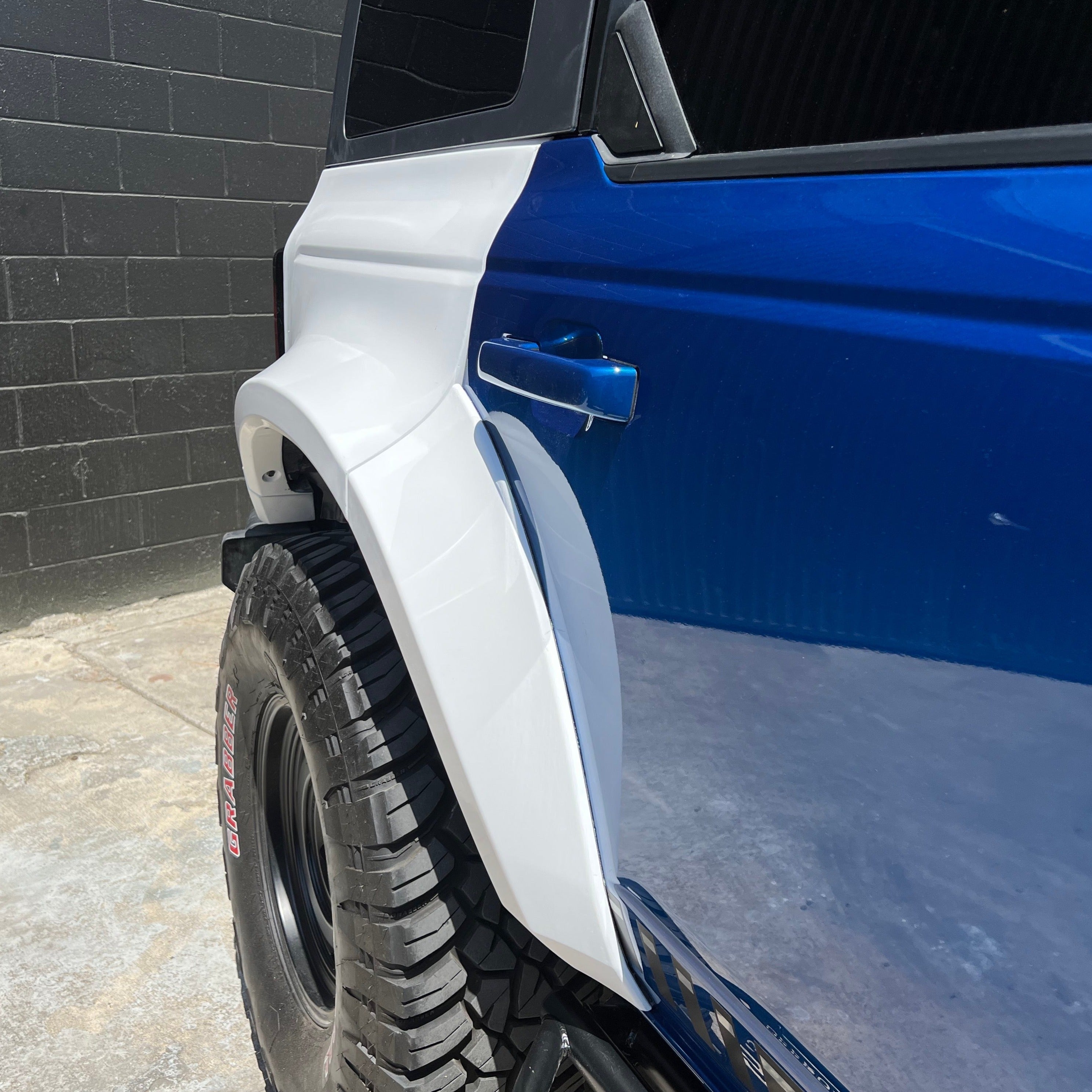 2021-2022 Ford Bronco 4-Door Rear Quarter Kit showcasing a sleek design and durable finish on a blue vehicle.