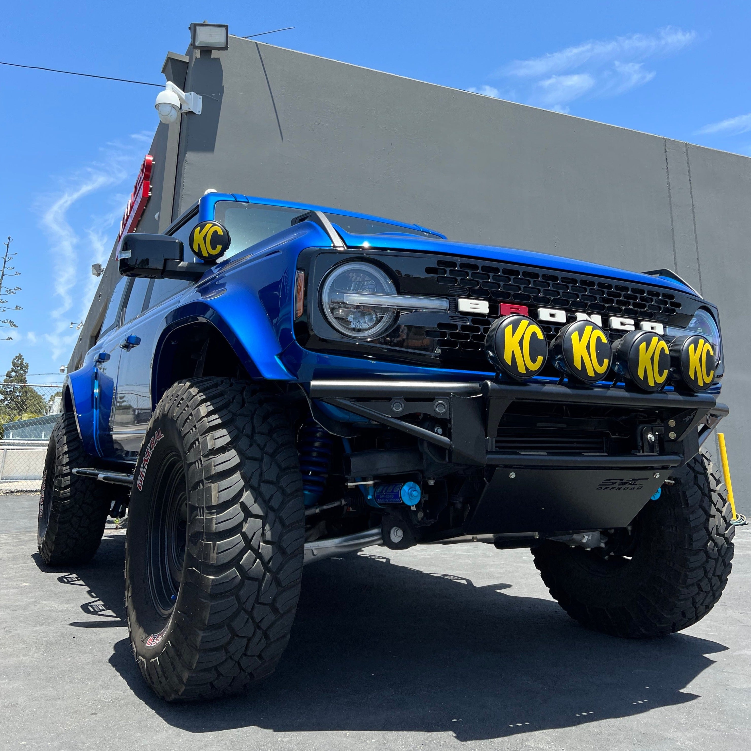 2021-2022 Ford Bronco with aftermarket fenders and off-road lights, showcasing a rugged, modified look.