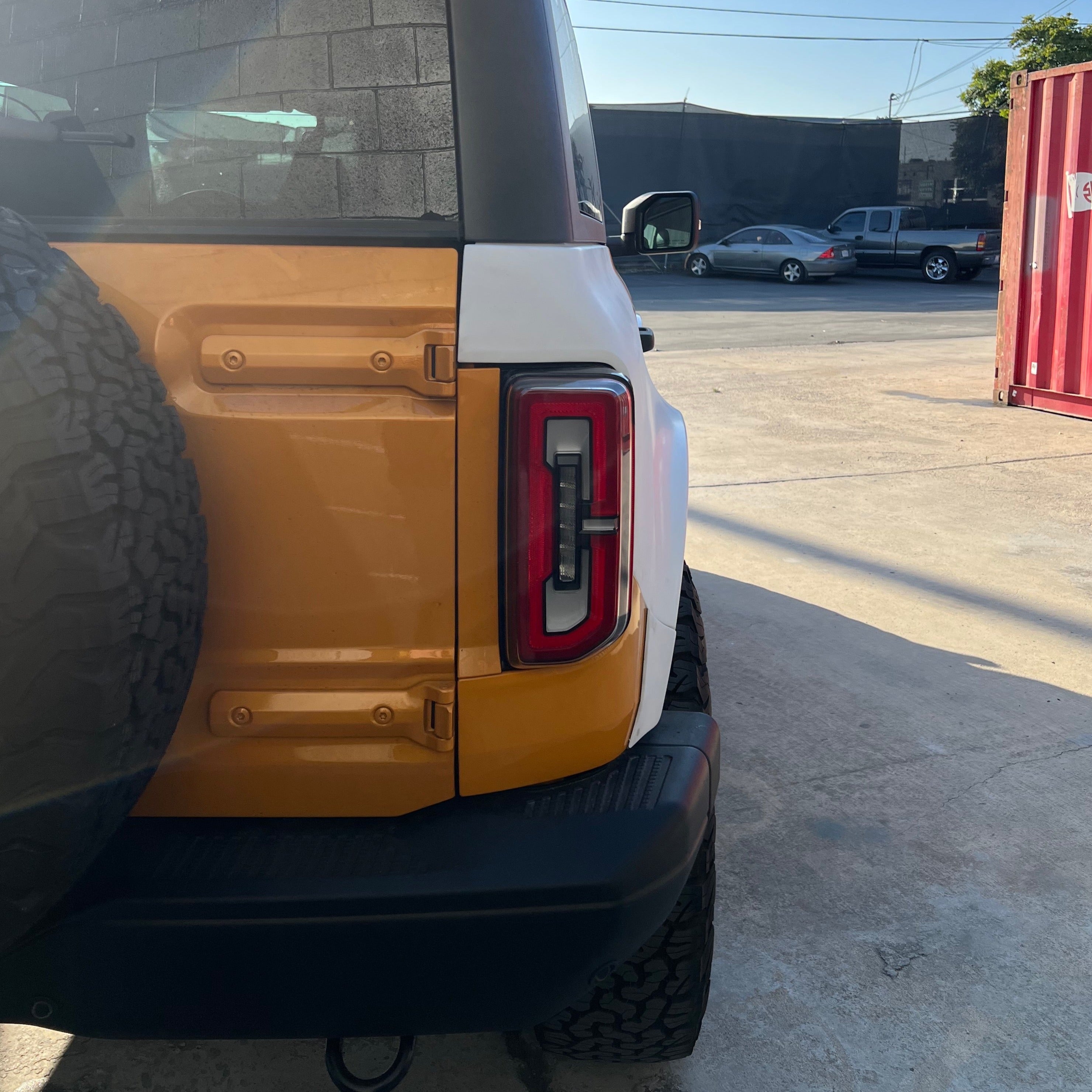 2021-2022 Ford Bronco 2-Door Rear Quarter Kit showcasing the rear design and taillight of the vehicle in a parking area.