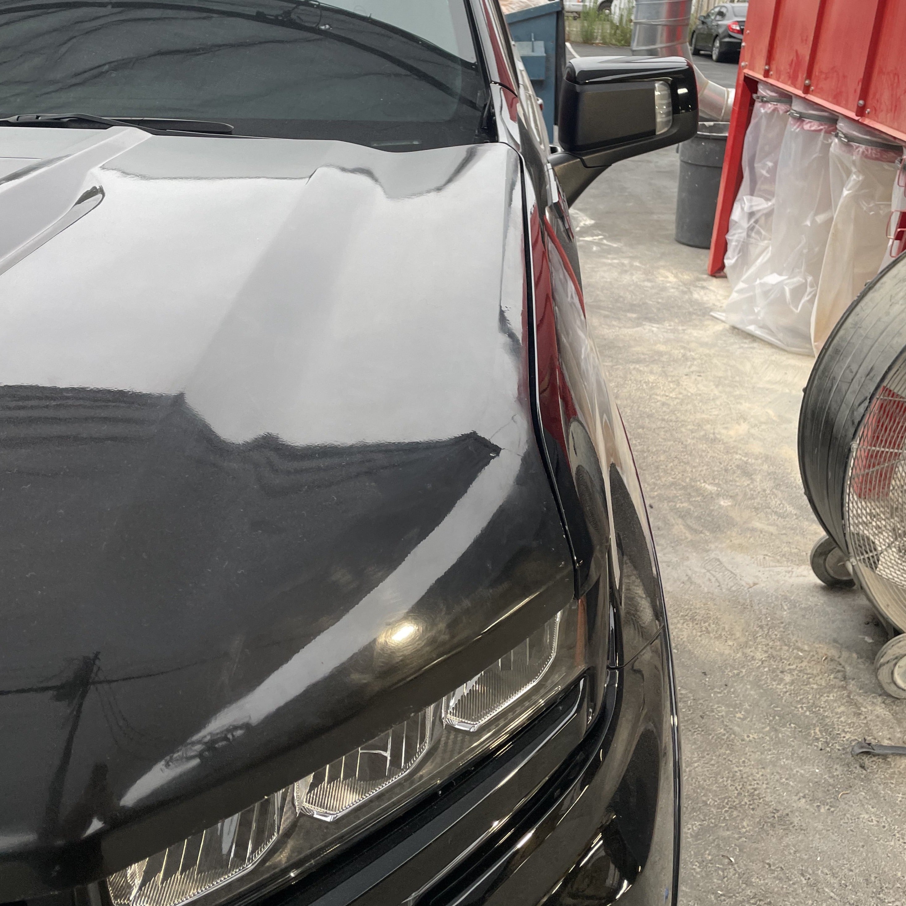 2019-2021 Chevrolet Silverado hood showcasing a sleek black finish and modern design details.