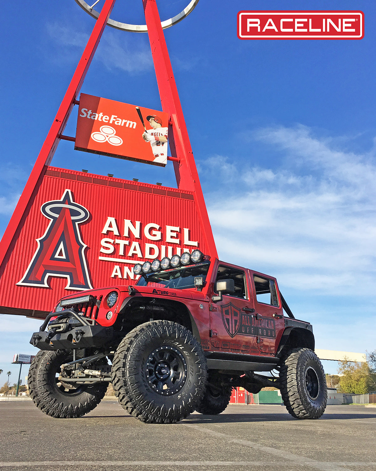 Black Jeep Wrangler 928B Monster with oversized tires and off-road lights parked near Angel Stadium, showcasing rugged design.