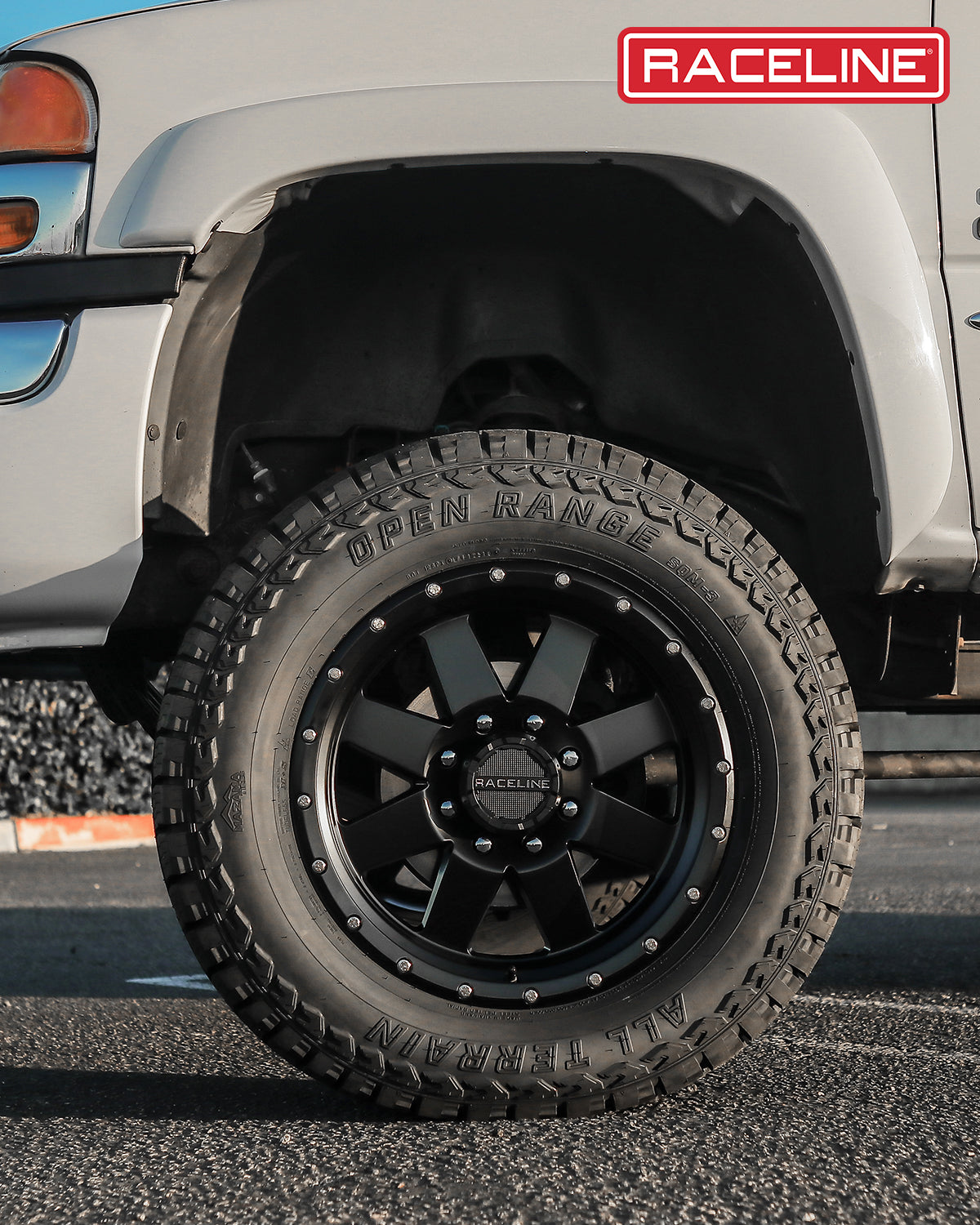 Black Raceline 935B Defender wheel mounted on a truck tire, showcasing rugged design and off-road capability.
