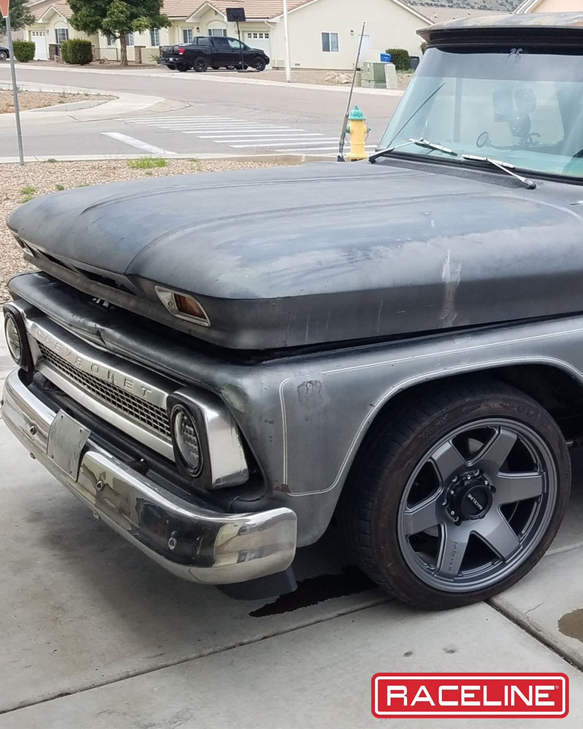 Classic Chevrolet truck with a weathered hood and modern Raceline wheels, showcasing a blend of vintage and contemporary style.
