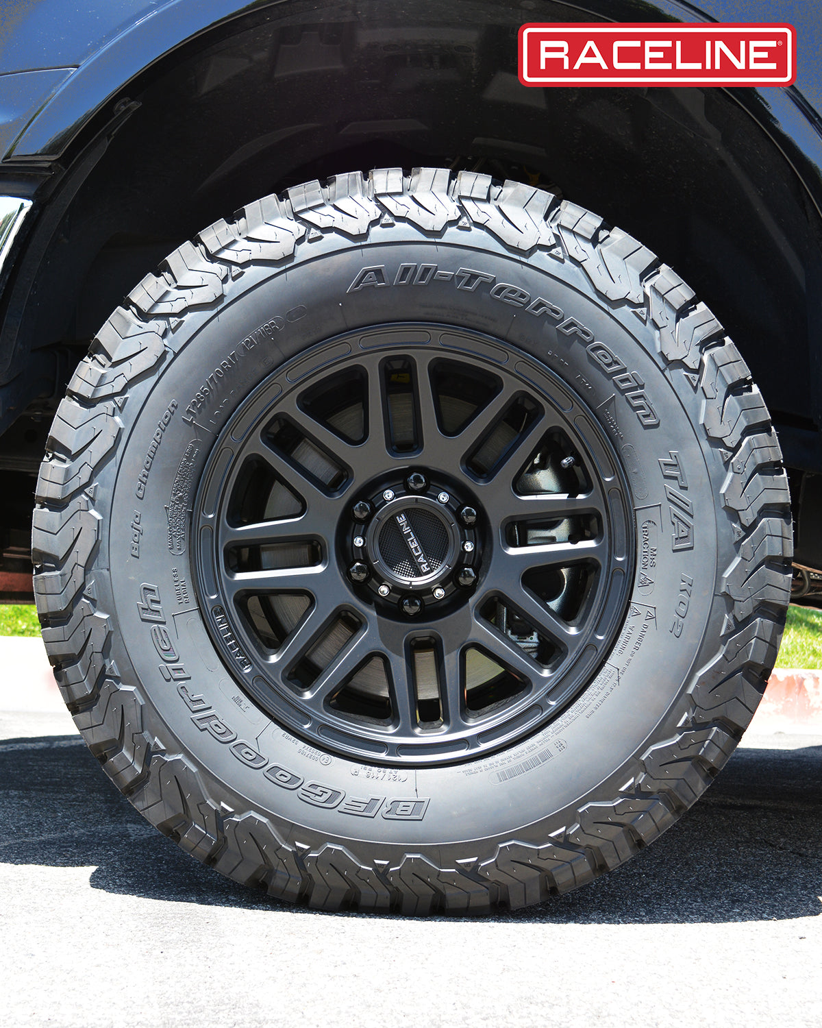 Black Raceline 944B Outlander wheel mounted on an all-terrain tire, showcasing rugged design for offroad performance.