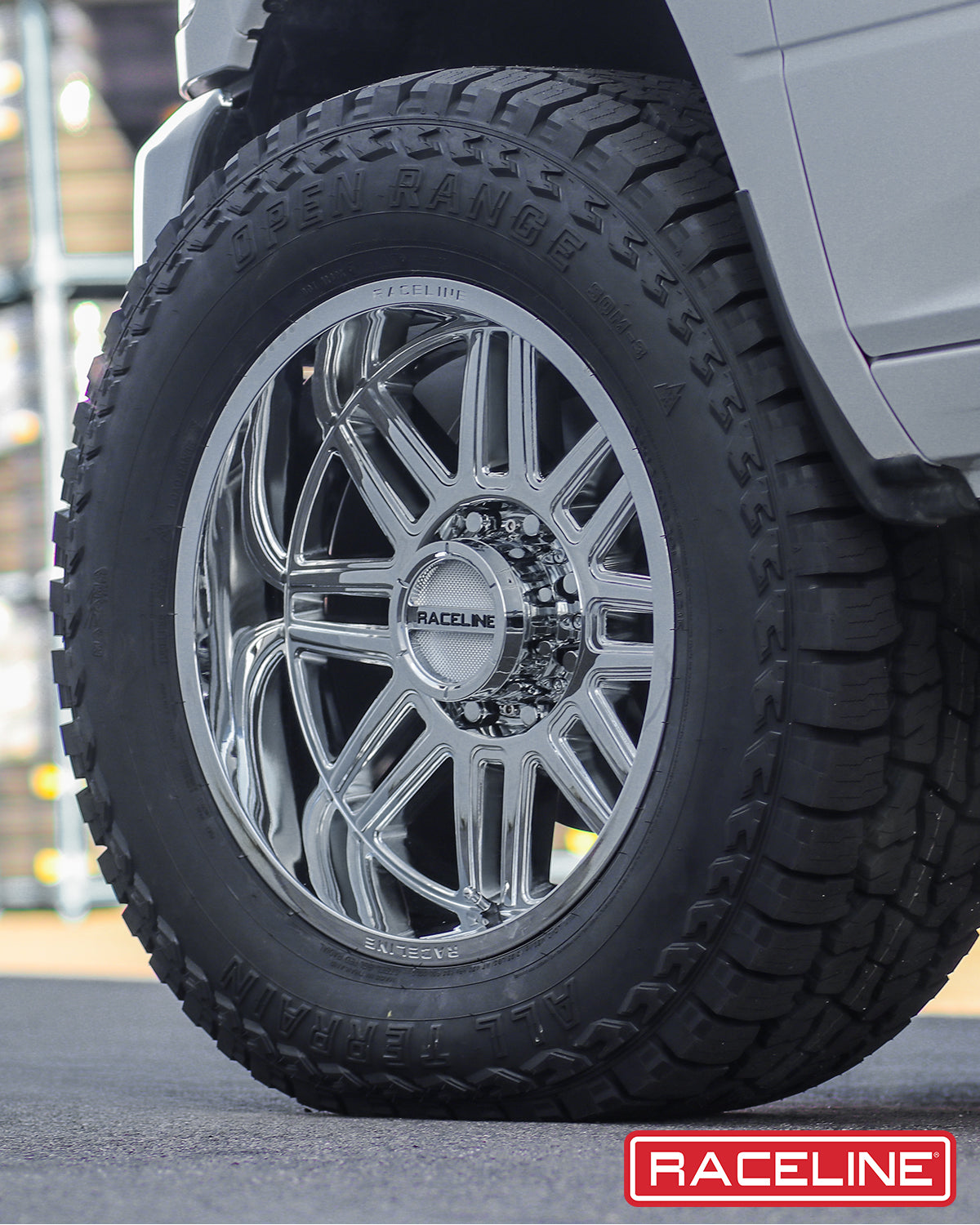 Chrome Raceline 948C Split wheel mounted on an off-road tire, showcasing a sleek design for trucks and SUVs.