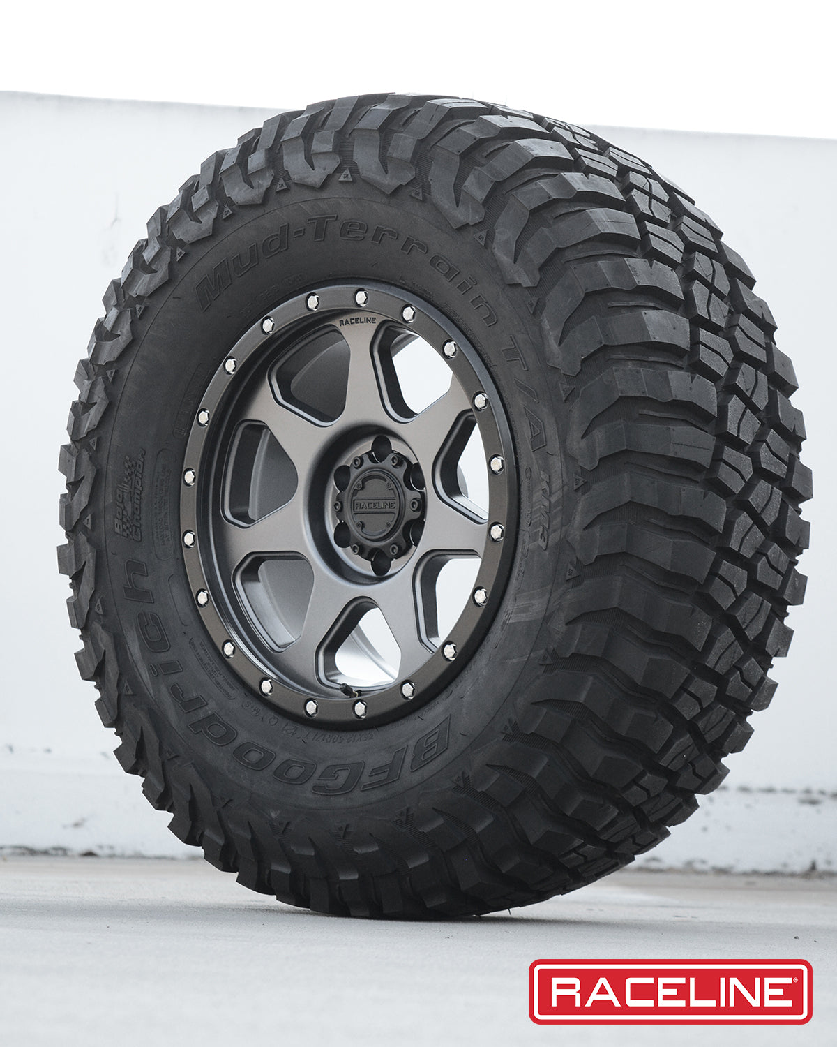 Raceline 949G 7X tire featuring a rugged tread pattern for off-road performance and a stylish alloy wheel design.