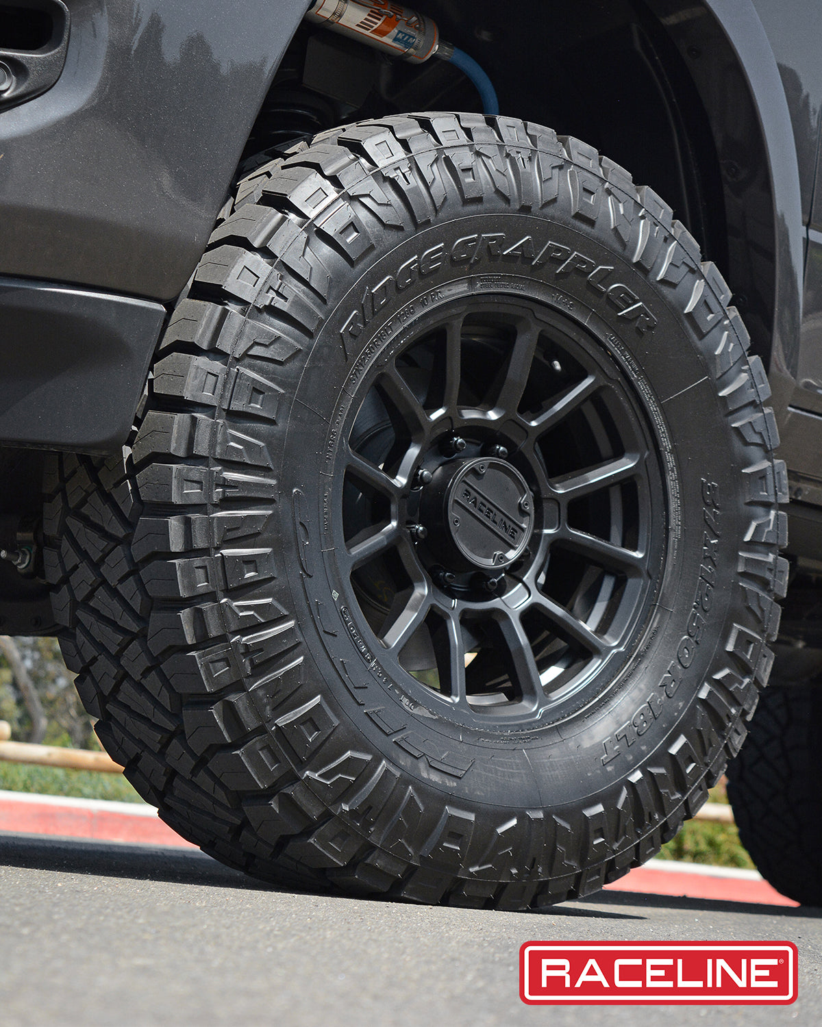 950B Gauge mounted on a rugged offroad tire, showcasing its durability and performance for trucks and SUVs.
