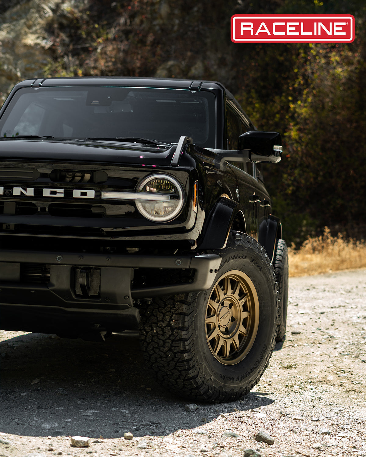 Black Ford Bronco with Raceline 952BZ Aero HD wheels parked on rugged terrain, showcasing offroad capabilities and style.