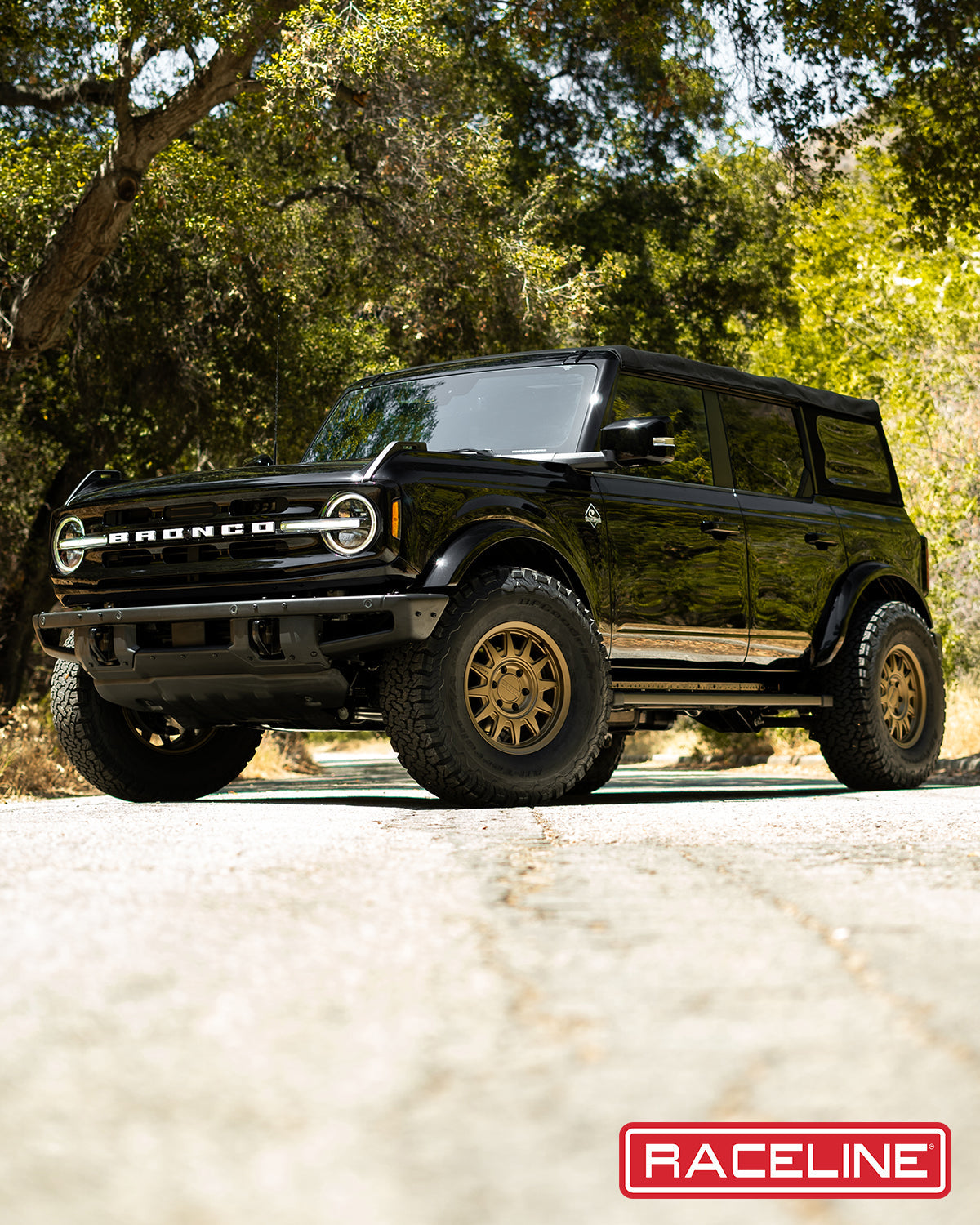 Black Ford Bronco equipped with 952BZ Aero HD wheels, showcasing rugged off-road capabilities in a natural setting.
