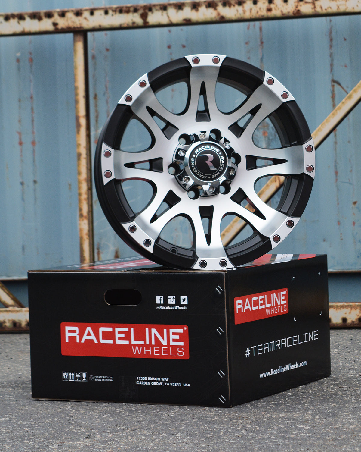 Machined 982 Raptor wheel displayed on a Raceline Wheels box, showcasing its sleek design and polished finish.
