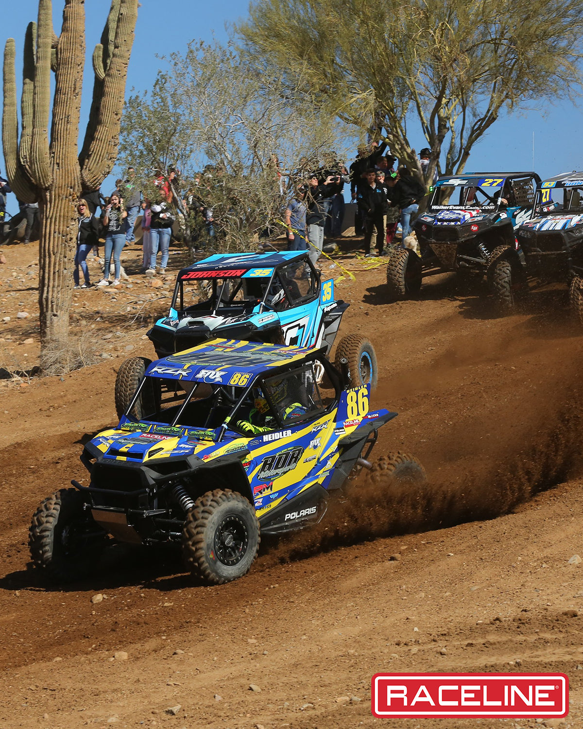 A91B Ryno Beadlock wheels on UTVs racing on a dirt track, showcasing offroad performance and rugged design.