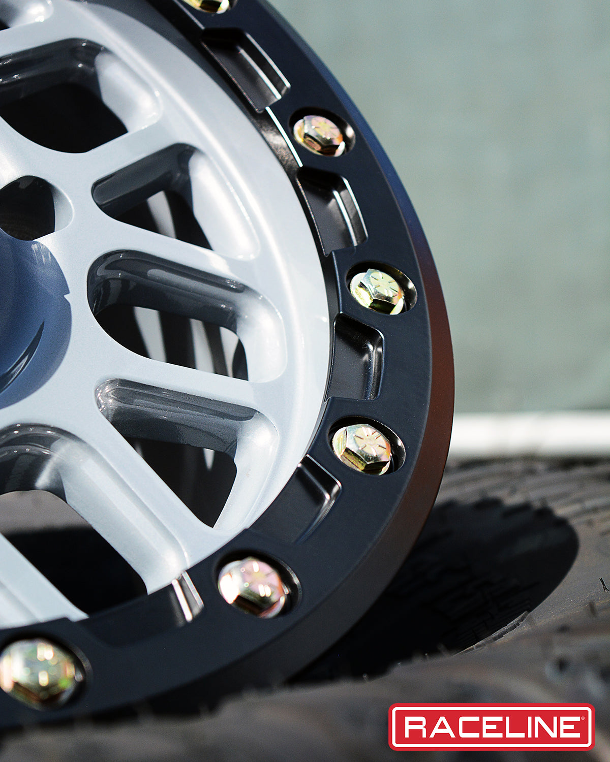 A93SG Podium Beadlock wheel showcasing a sleek design with a silver finish and black beadlock ring.