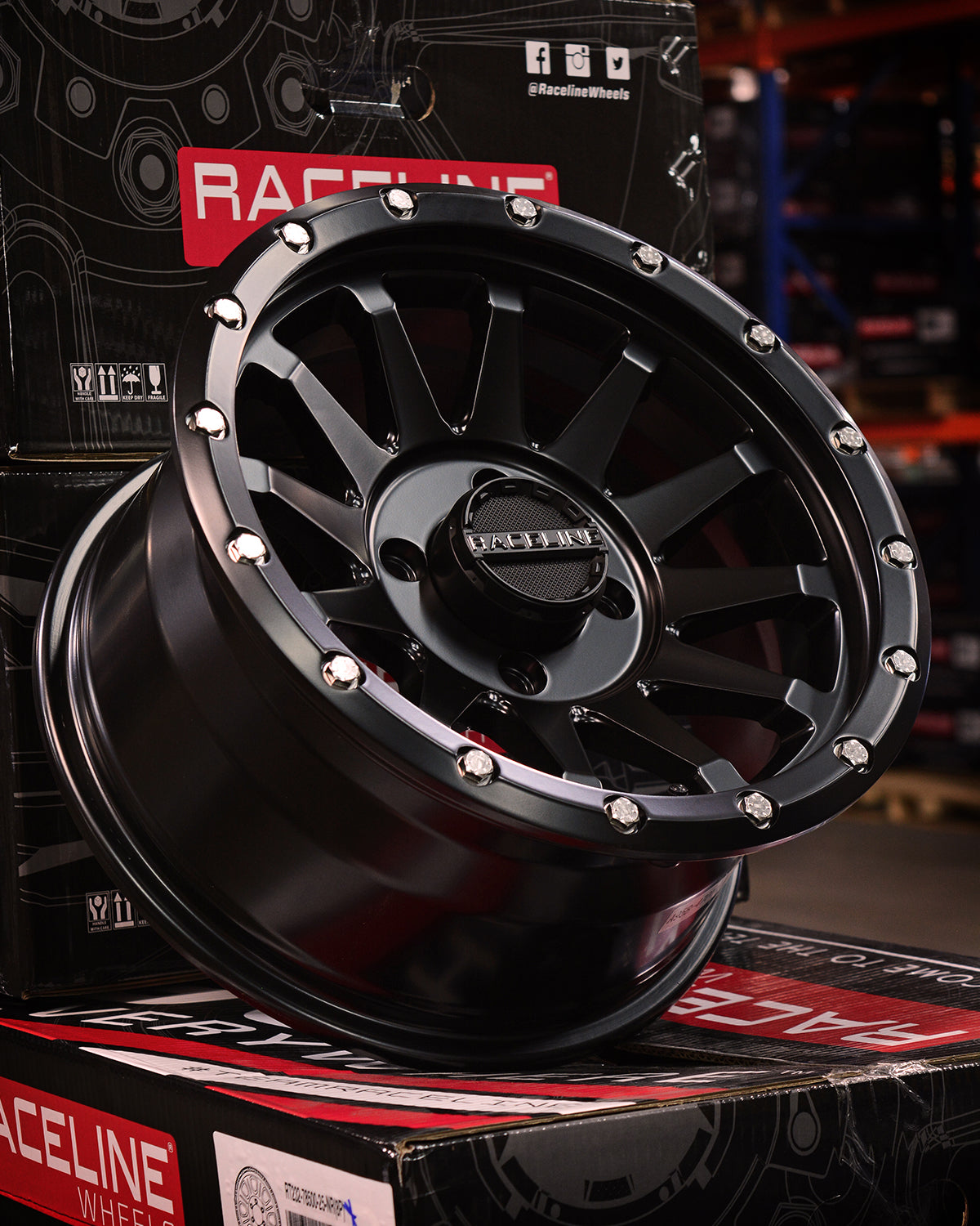 A95B Trophy Simulated Beadlock wheel with a sleek black finish and chrome accents, displayed on a branded box.