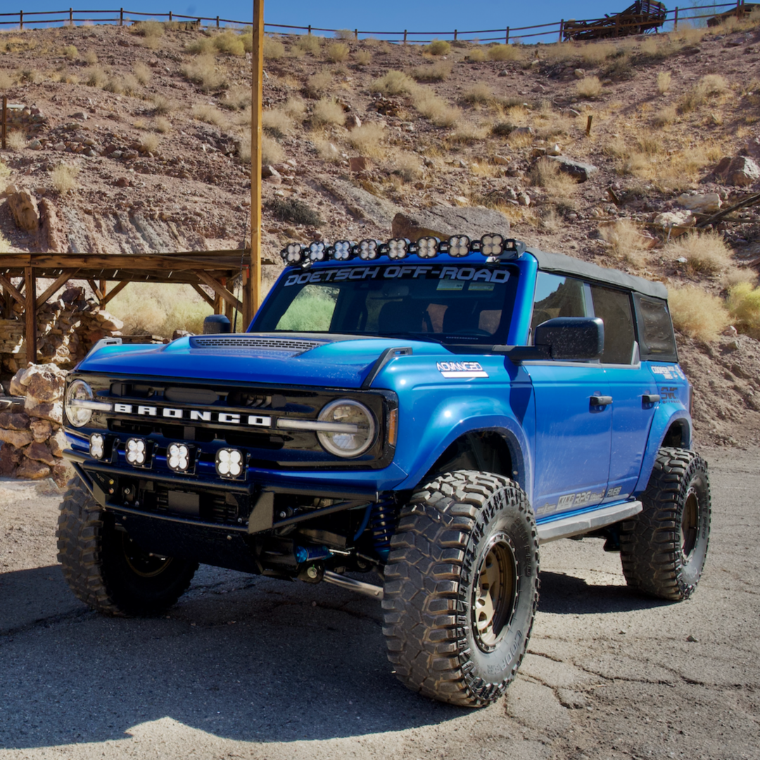 2021-2022 Ford Bronco fenders showcased on a modified blue Bronco with off-road lights and rugged tires.