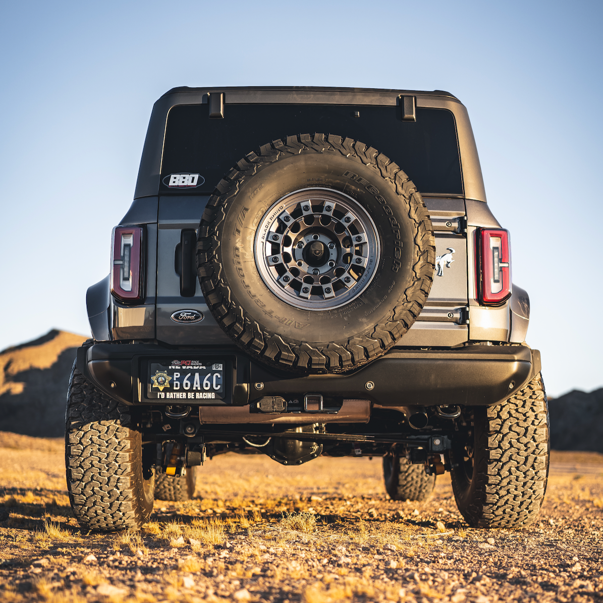 2021-2022 Ford Bronco 4-Door with rear quarter kit showcasing rugged tires and off-road capabilities in a desert setting.