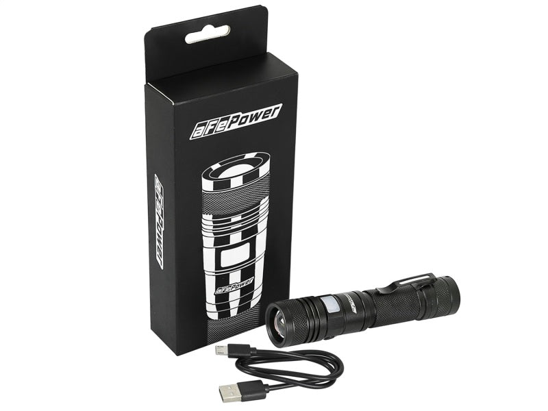 aFe Power LED flashlight with 950 lumens, displayed next to its packaging and a USB charging cable.