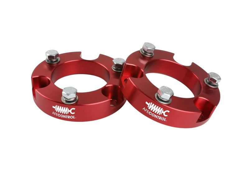 aFe CONTROL 2.0 IN Leveling Kit for 2005-2021 Toyota 4Runner, FJ Cruiser, and Tacoma in red aluminum with bolts.