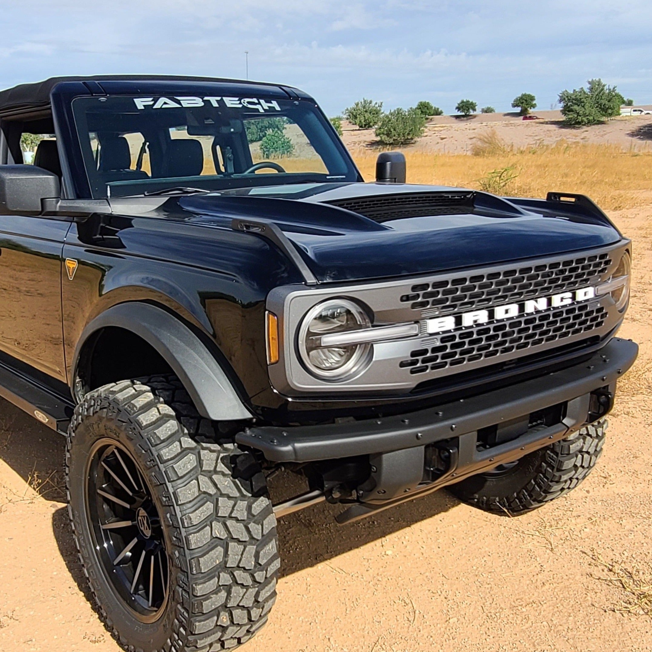 2021-2024 Ford Bronco with Ram Air Hood showcasing a sleek design and off-road capabilities in a desert setting.