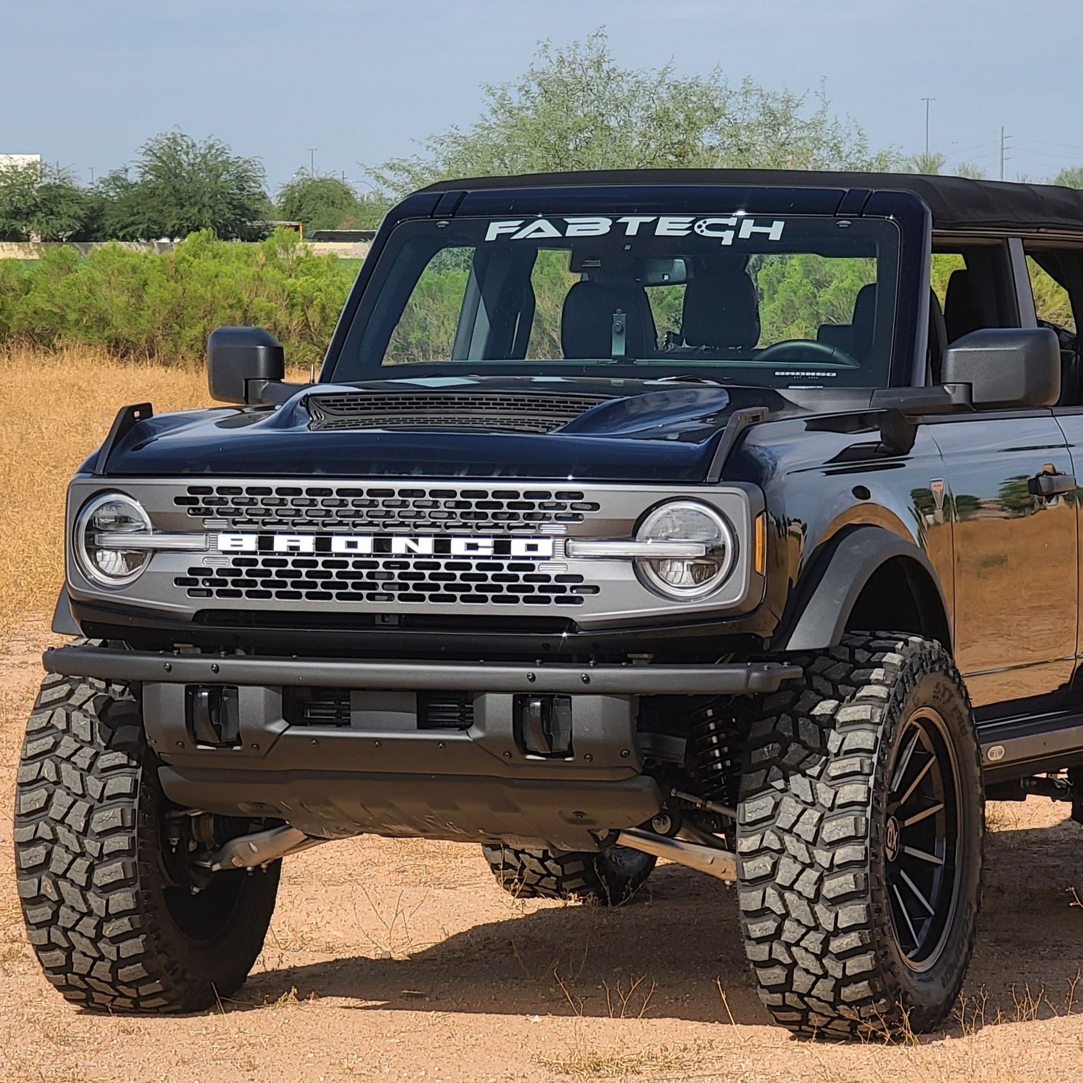 2021-2024 Ford Bronco with a Ram Air Hood, showcasing rugged design and off-road capability in a desert setting.