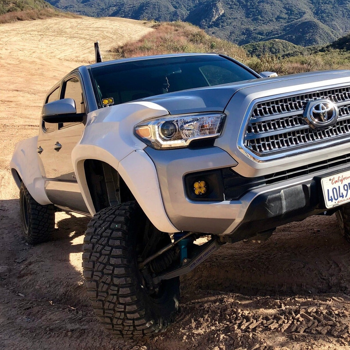 2016-2022 Toyota Tacoma with aftermarket bedsides, showcasing offroad capabilities on rugged terrain.