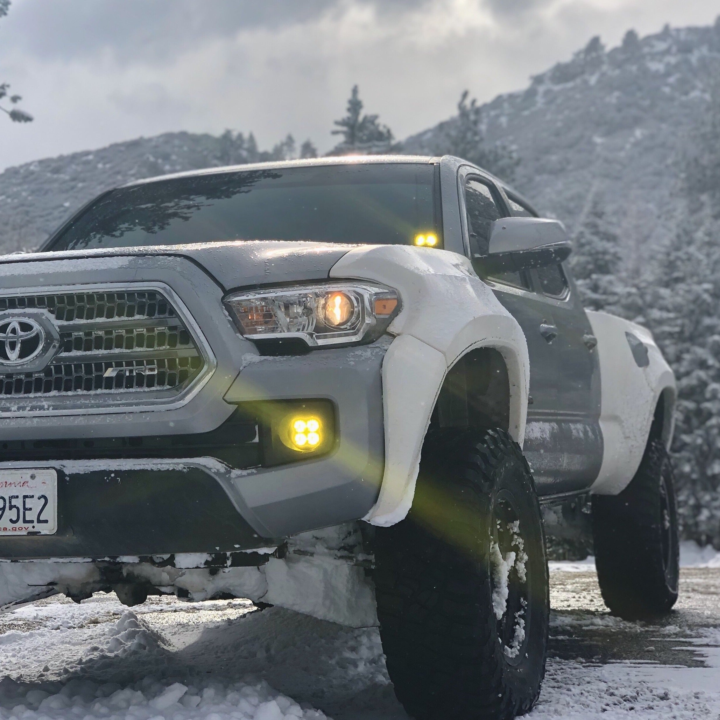 2016-2022 Toyota Tacoma fenders on a truck in a snowy landscape, showcasing rugged design and off-road capability.