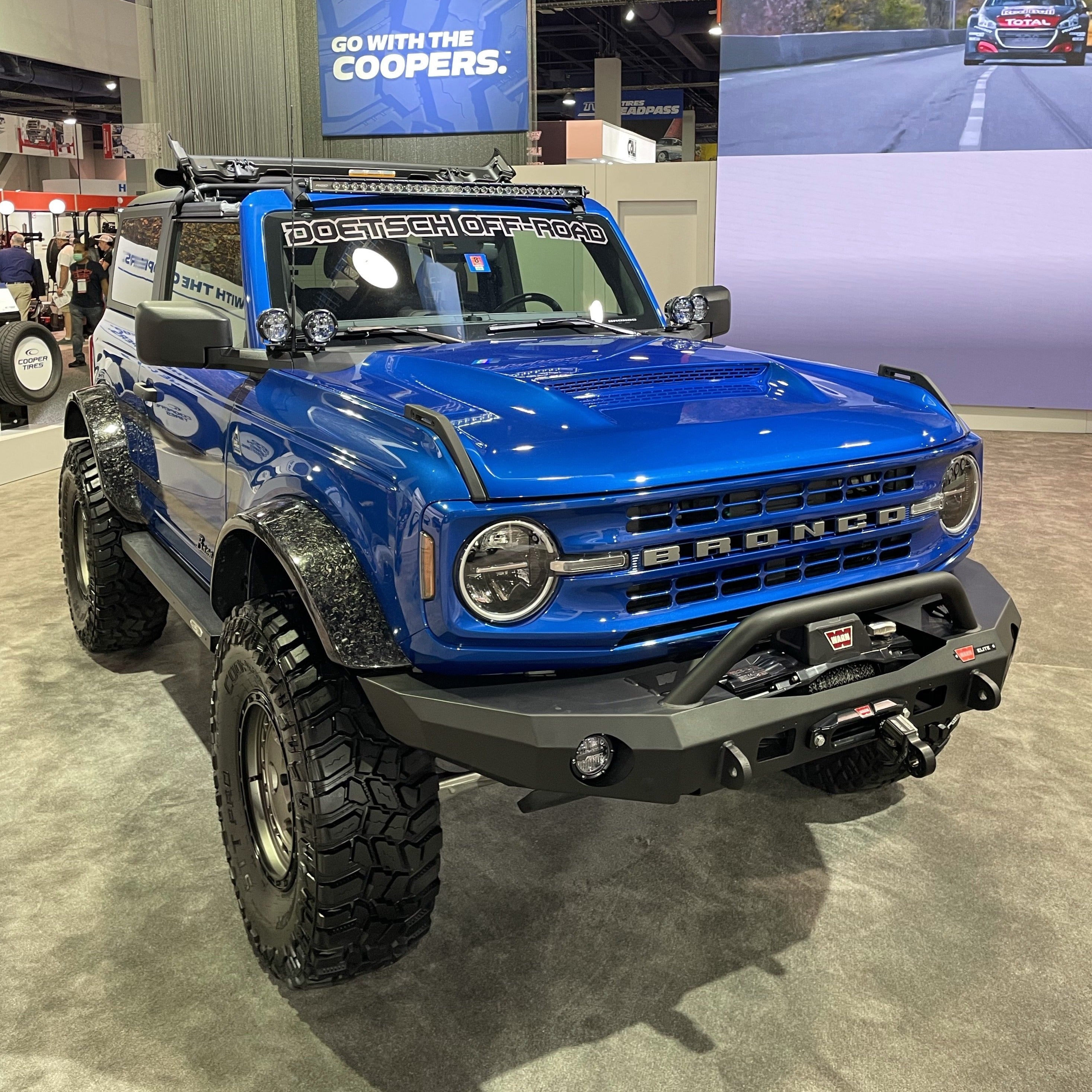 2021-2024 Ford Bronco with Ram Air Hood displayed at an automotive expo, showcasing offroad capabilities and rugged design.