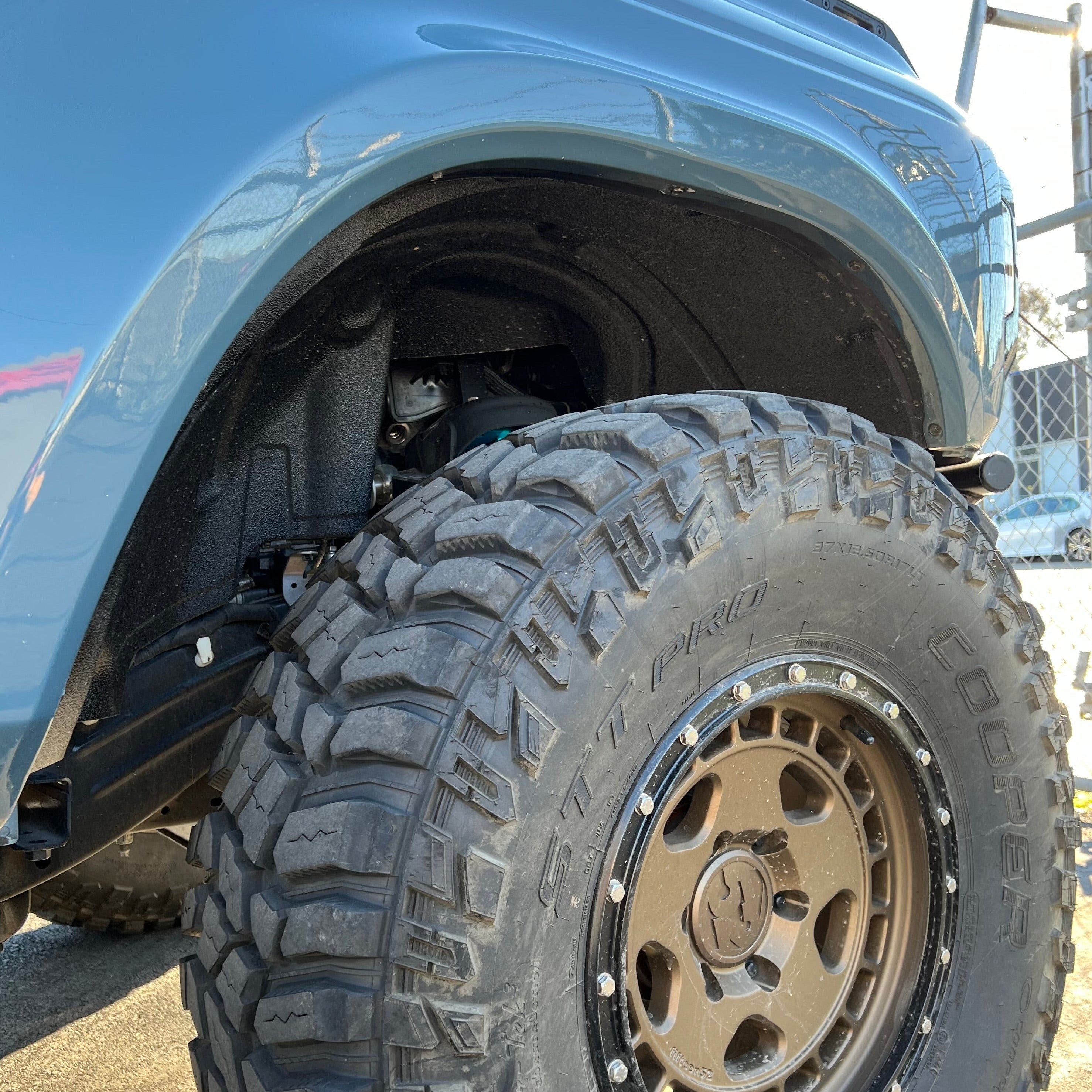 2021-2022 Ford Bronco fenders showcasing a rugged tire and suspension setup for enhanced off-road performance.