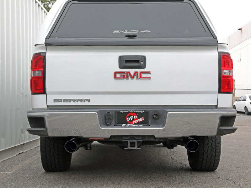 Rear view of a GMC Sierra truck showcasing the aFe Apollo GT Series Cat-Back Exhaust System with dual exhaust tips.