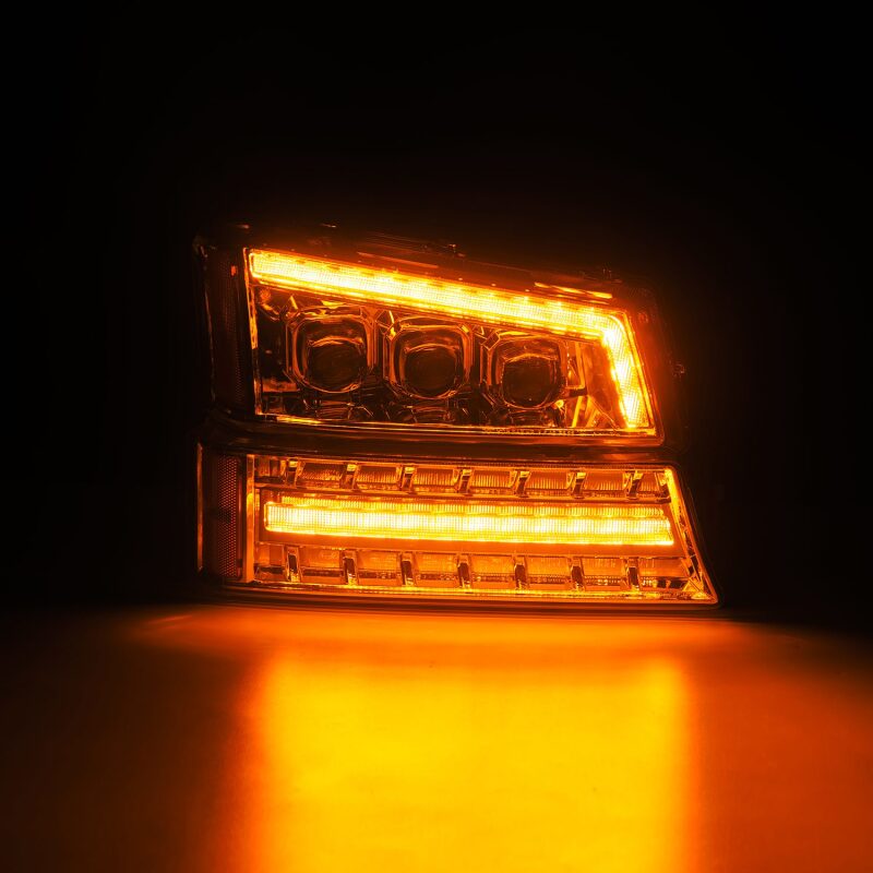 AlphaRex Chrome NOVA LED projector headlights for 03-06 Chevy Silverado and Avalanche with bright amber lighting.